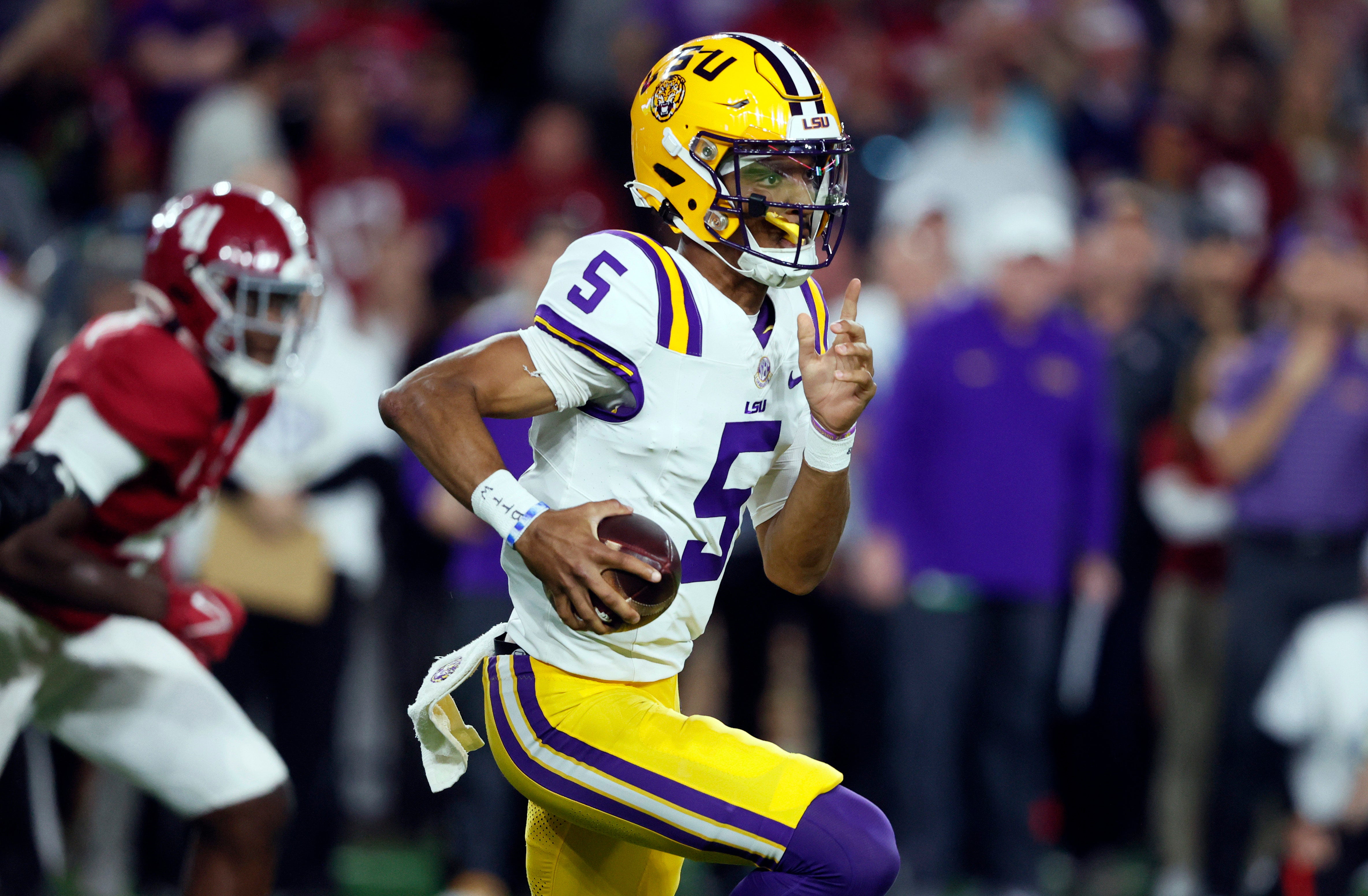 Nov 4, 2023; Tuscaloosa, Alabama, USA; LSU Tigers quarterback Jayden Daniels (5) scrambles for a first down during the first half against Alabama Crimson Tide at Bryant-Denny Stadium.