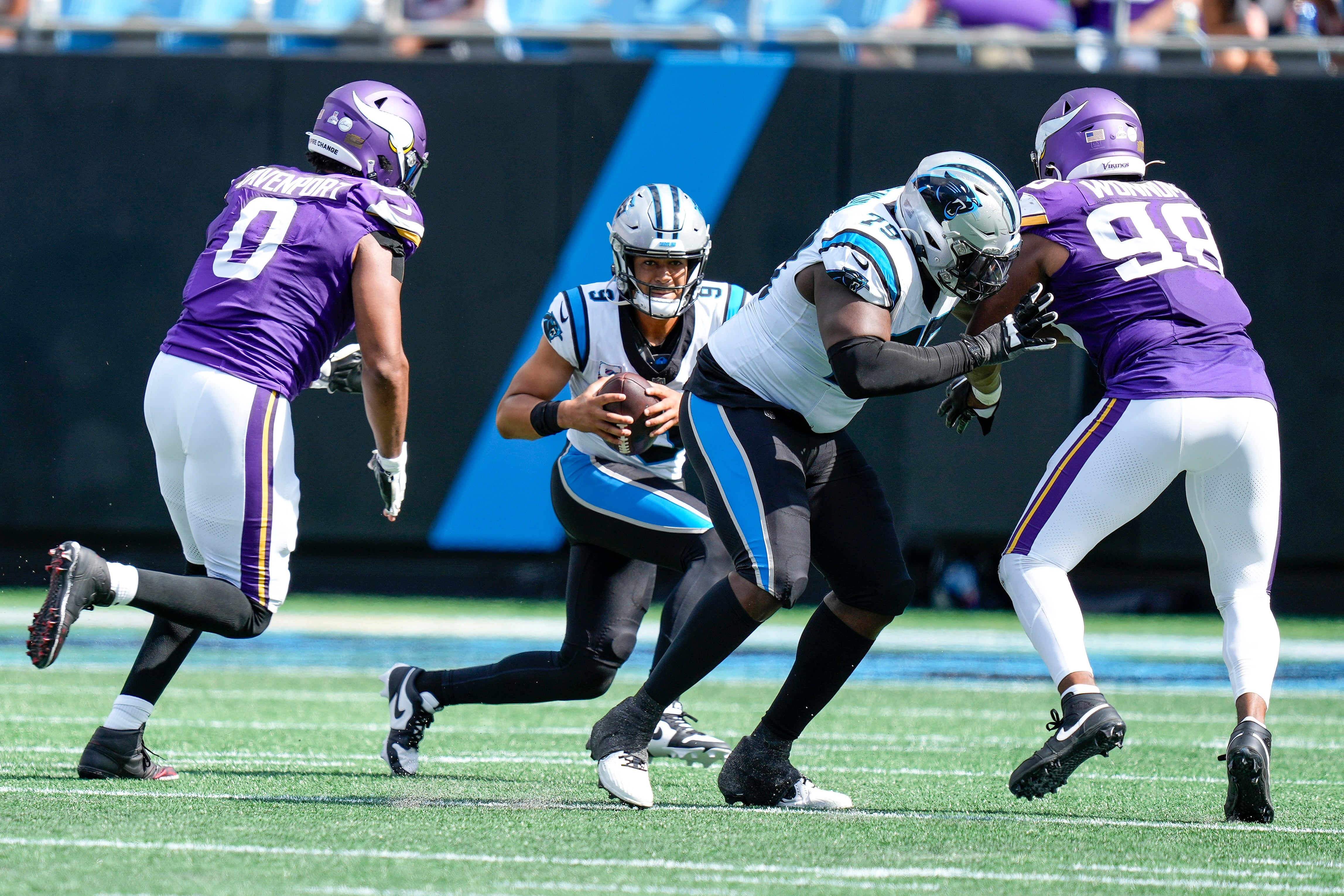 Oct 1, 2023; Charlotte, North Carolina, USA; Carolina Panthers quarterback Bryce Young (9) is pressured by Minnesota Vikings linebacker Marcus Davenport (0) and linebacker D.J. Wonnum (98) during the second half at Bank of America Stadium. Mandatory Credit: Jim Dedmon-USA TODAY Sports