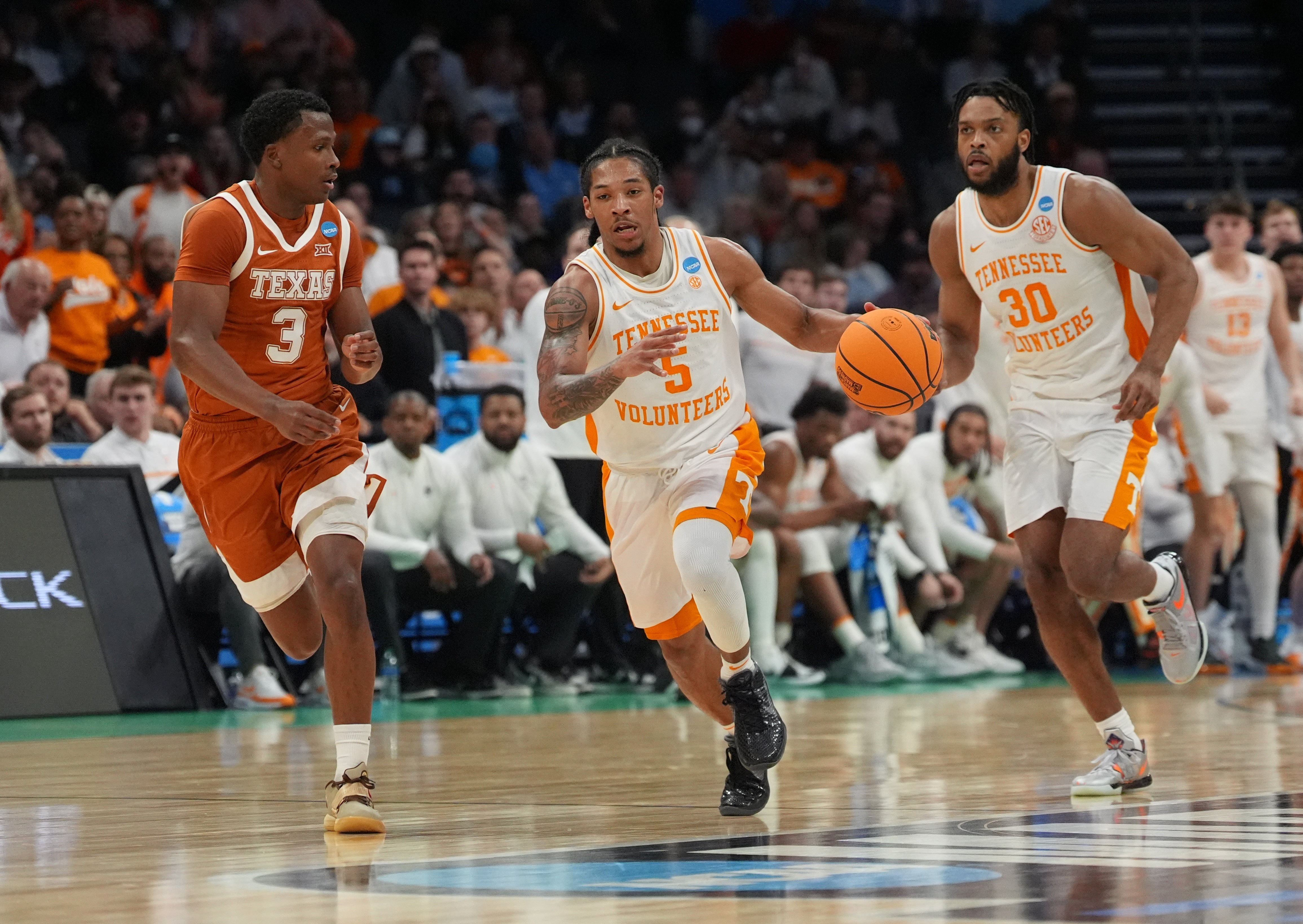 March 23, 2024, Charlotte, NC, USA; Tennessee Volunteers guard Zakai Zeigler (5) dribbles against Texas Longhorns guard Max Abmas (3) in the second round of the 2024 NCAA Tournament at the Spectrum Center.