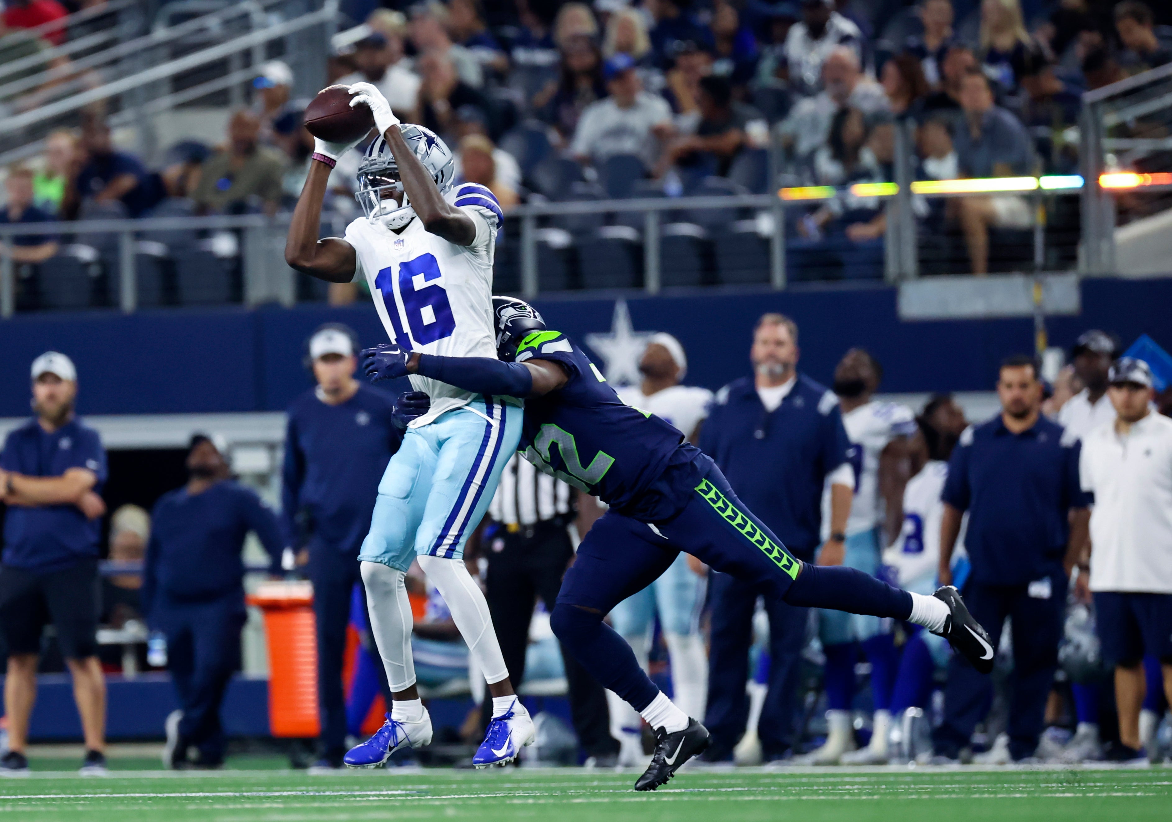 Dallas Cowboys wide receiver T.J. Vasher (16) makes a catch in front of Seattle Seahawks cornerback Jameson Houston (32) during the fourth quarter at AT&T Stadium.