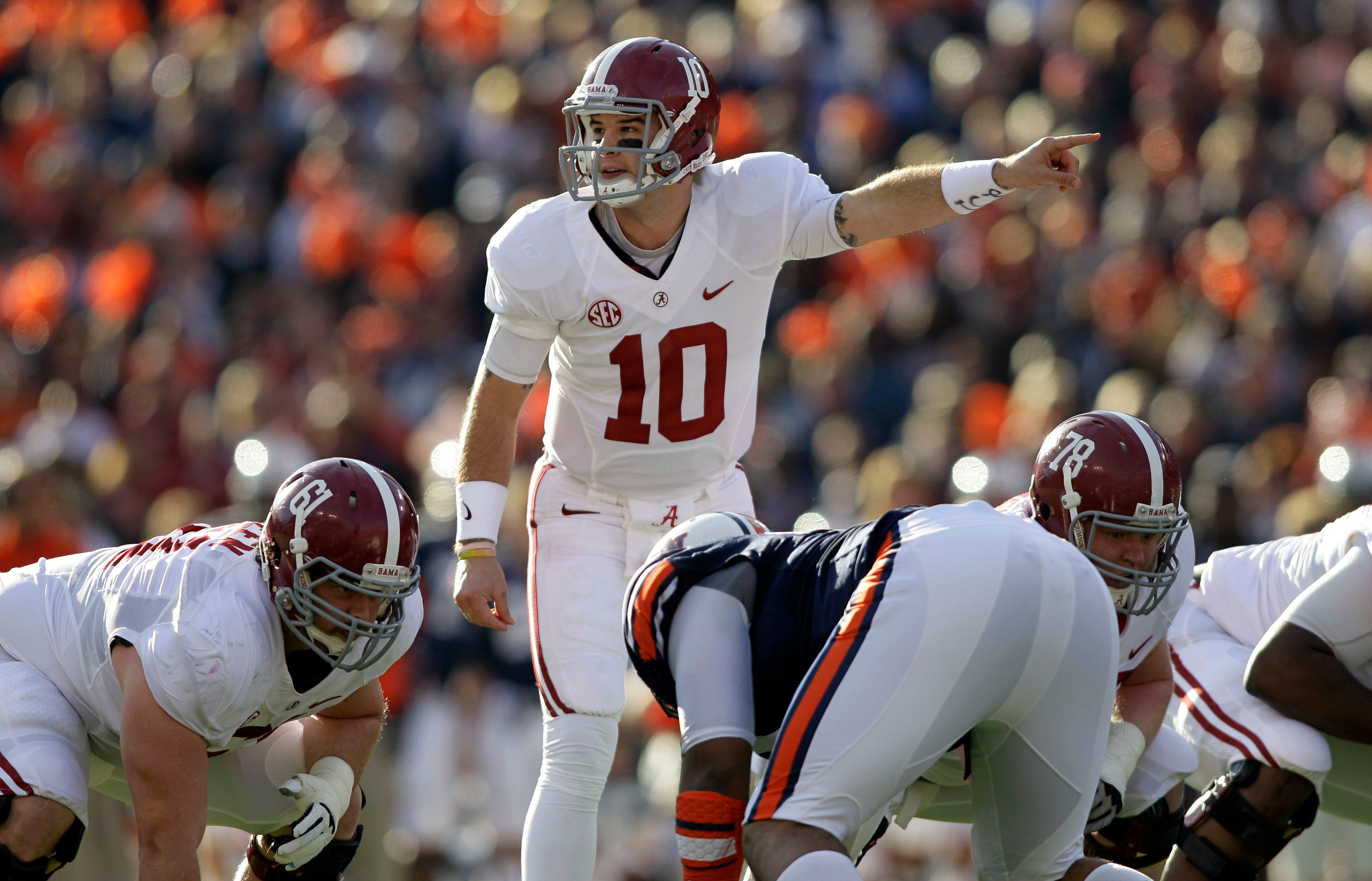 Nov 30, 2013; Auburn, AL, USA; Alabama Crimson Tide quarterback AJ McCarron (10) signals at the line of scrimmage during the first quarter against the Auburn Tigers at Jordan Hare Stadium.
