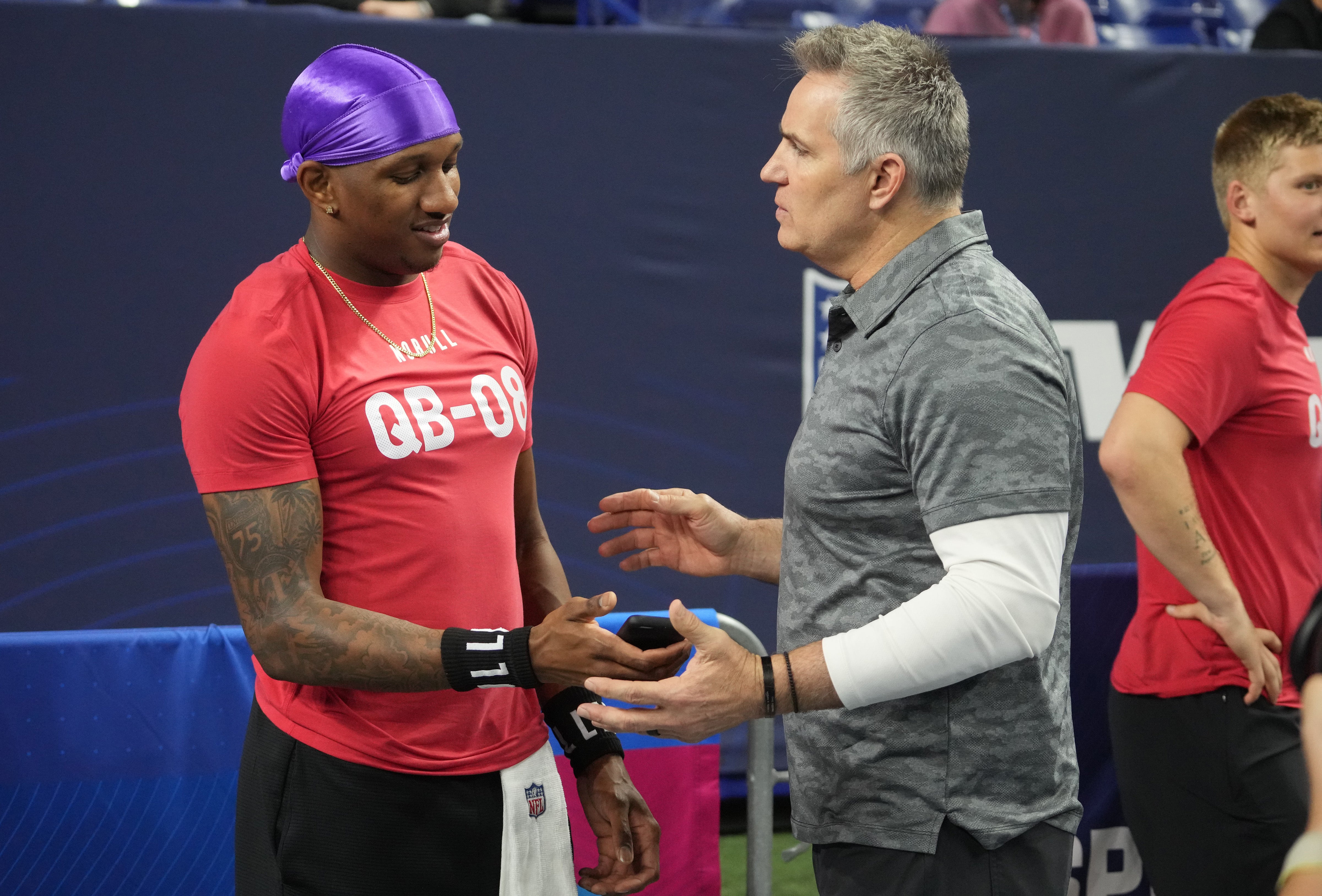 Mar 2, 2024; Indianapolis, IN, USA; Washington quarterback Michael Penix (QB08) talks to NFL Hall of Fame player Curt Warner during the 2024 NFL Combine at Lucas Oil Stadium. Mandatory Credit: Kirby Lee-USA TODAY Sports