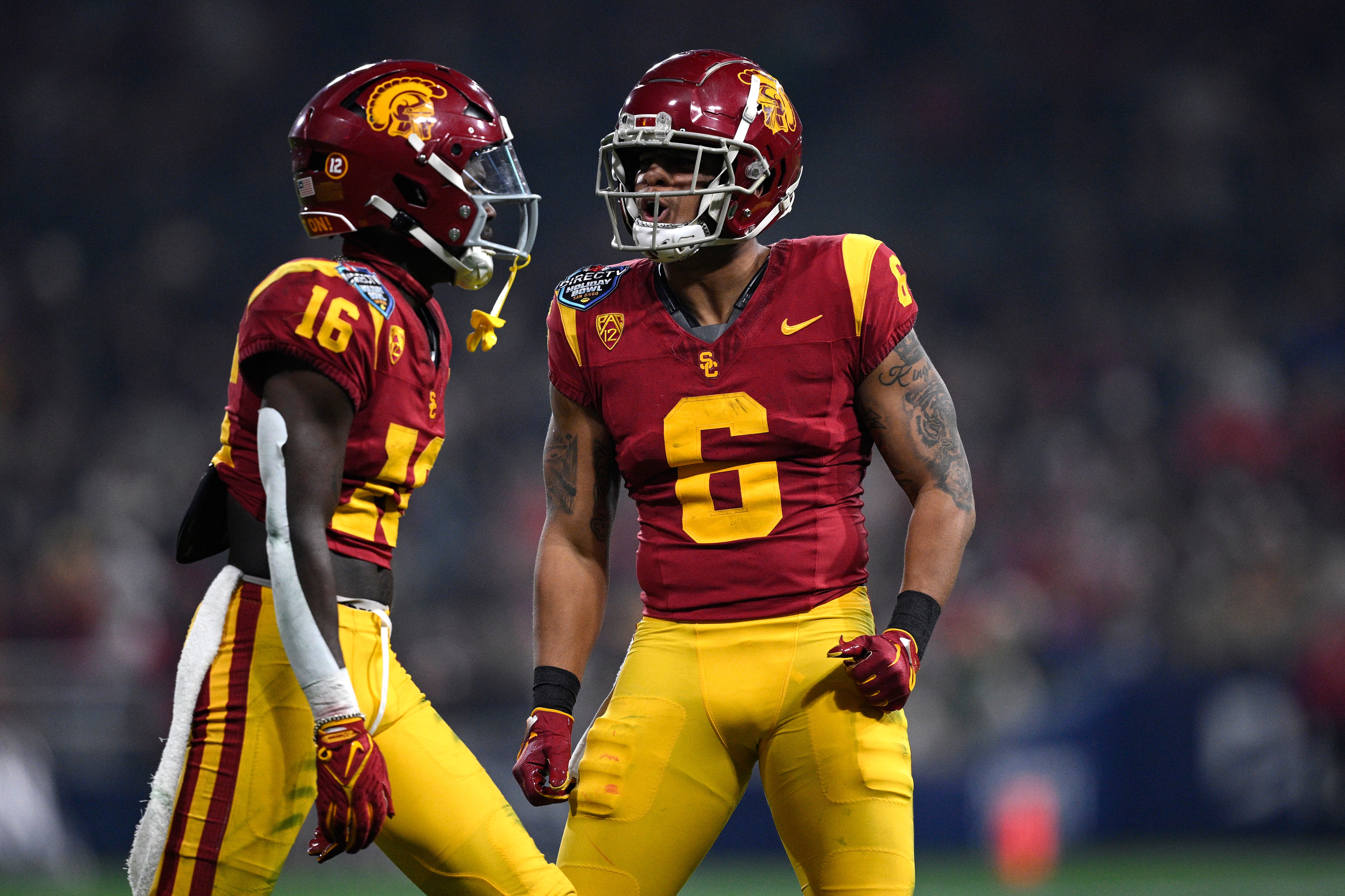 Dec 27, 2023; San Diego, CA, USA; USC Trojans wide receiver Tahj Washington (16) celebrates with running back Austin Jones (6) after a touchdown against the Louisville Cardinals during the first half at Petco Park.