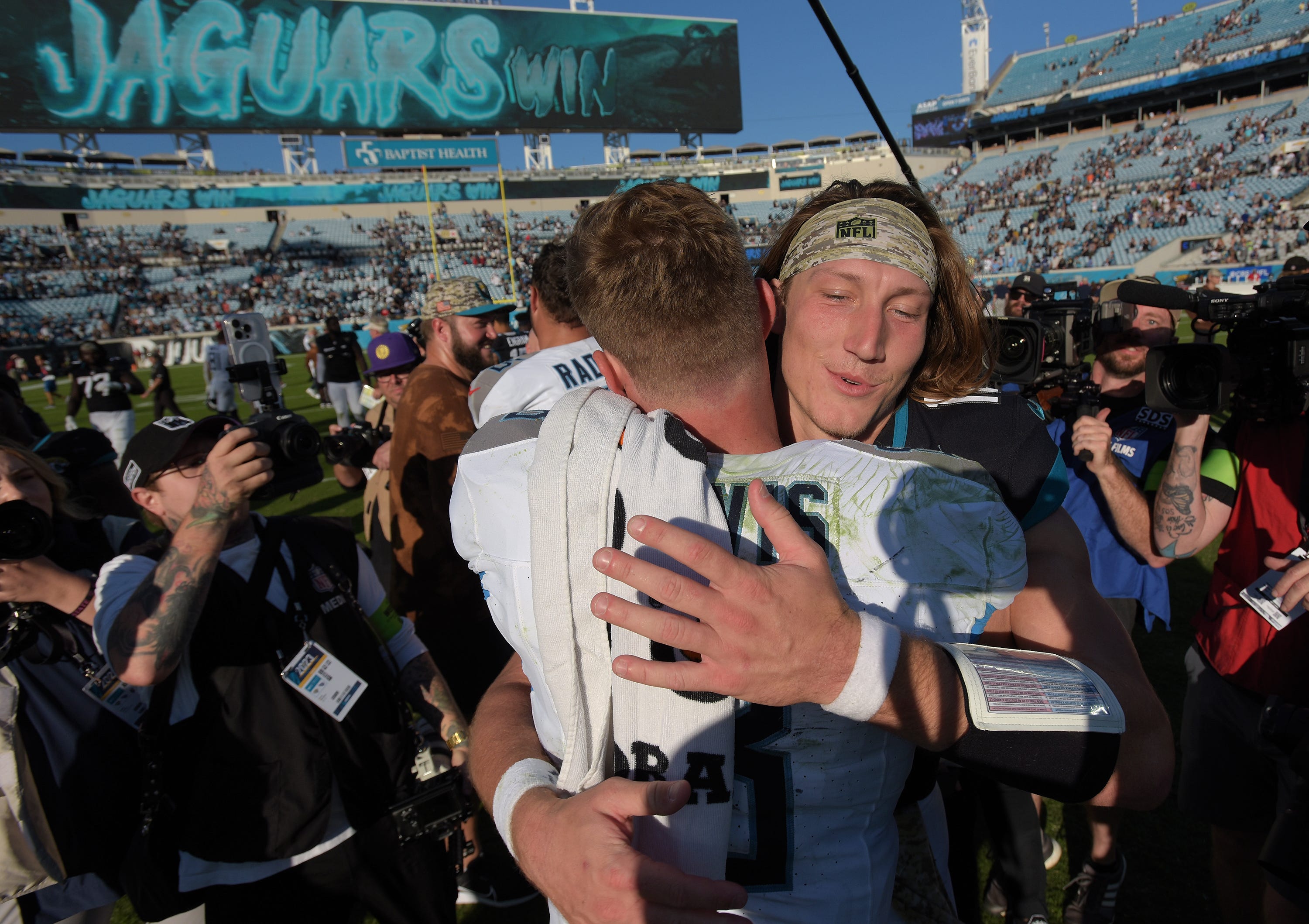 Jacksonville Jaguars quarterback Trevor Lawrence (16) hugs Tennessee Titans quarterback Will Levis (8) after Sunday's Jaguars victory. The Jacksonville Jaguars hosted the Tennessee Titans at EverBank Stadium in Jacksonville, FL Sunday, November 19, 2023. The Jaguars led 13 to 0 at the half and walked away with a 34 to 14 win over the Titans.