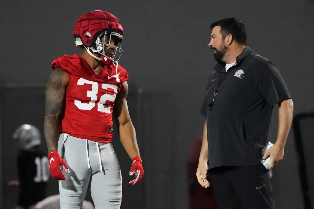 Ohio State Buckeyes head coach Ryan Day talks to running back TreVeyon Henderson (32) during spring football practice at the Woody Hayes Athletic Center
