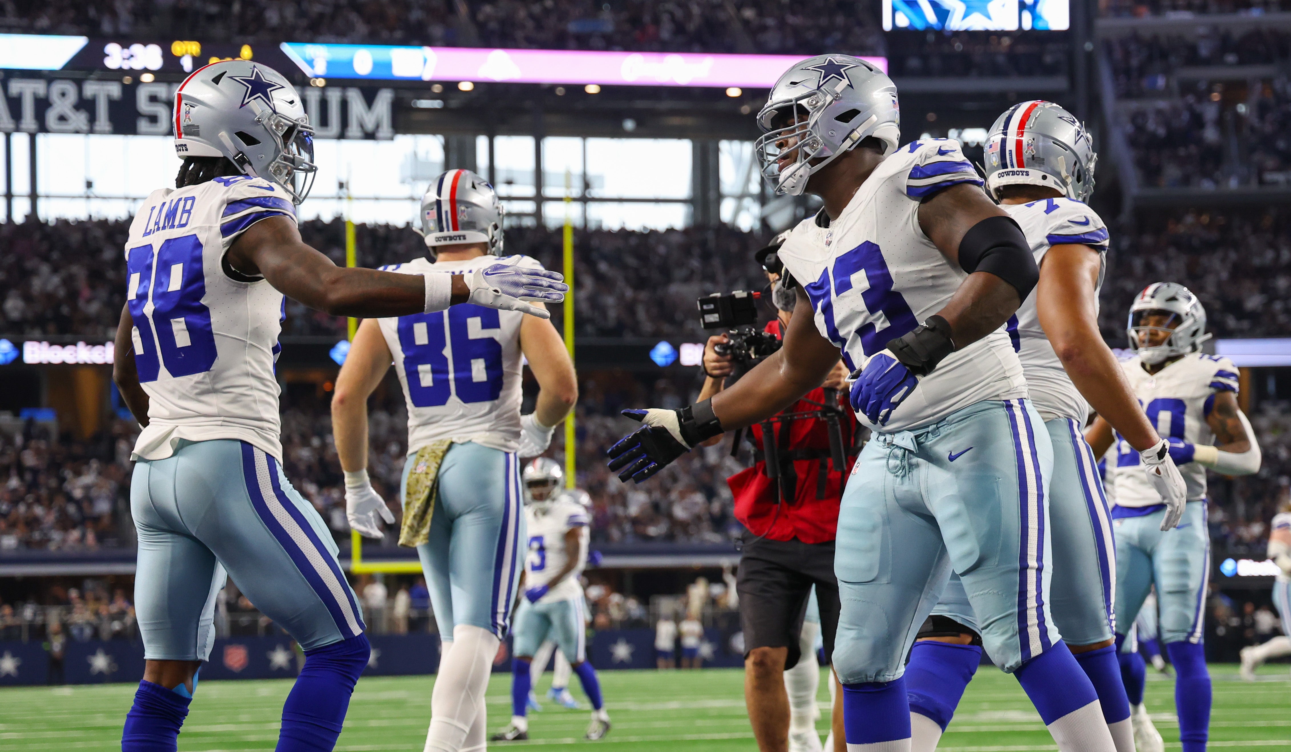 Dallas Cowboys wide receiver CeeDee Lamb (88) celebrates with Dallas Cowboys offensive tackle Tyler Smith (73) after scoring a touchdown during the first quarter against the New York Giants at AT&T Stadium.
