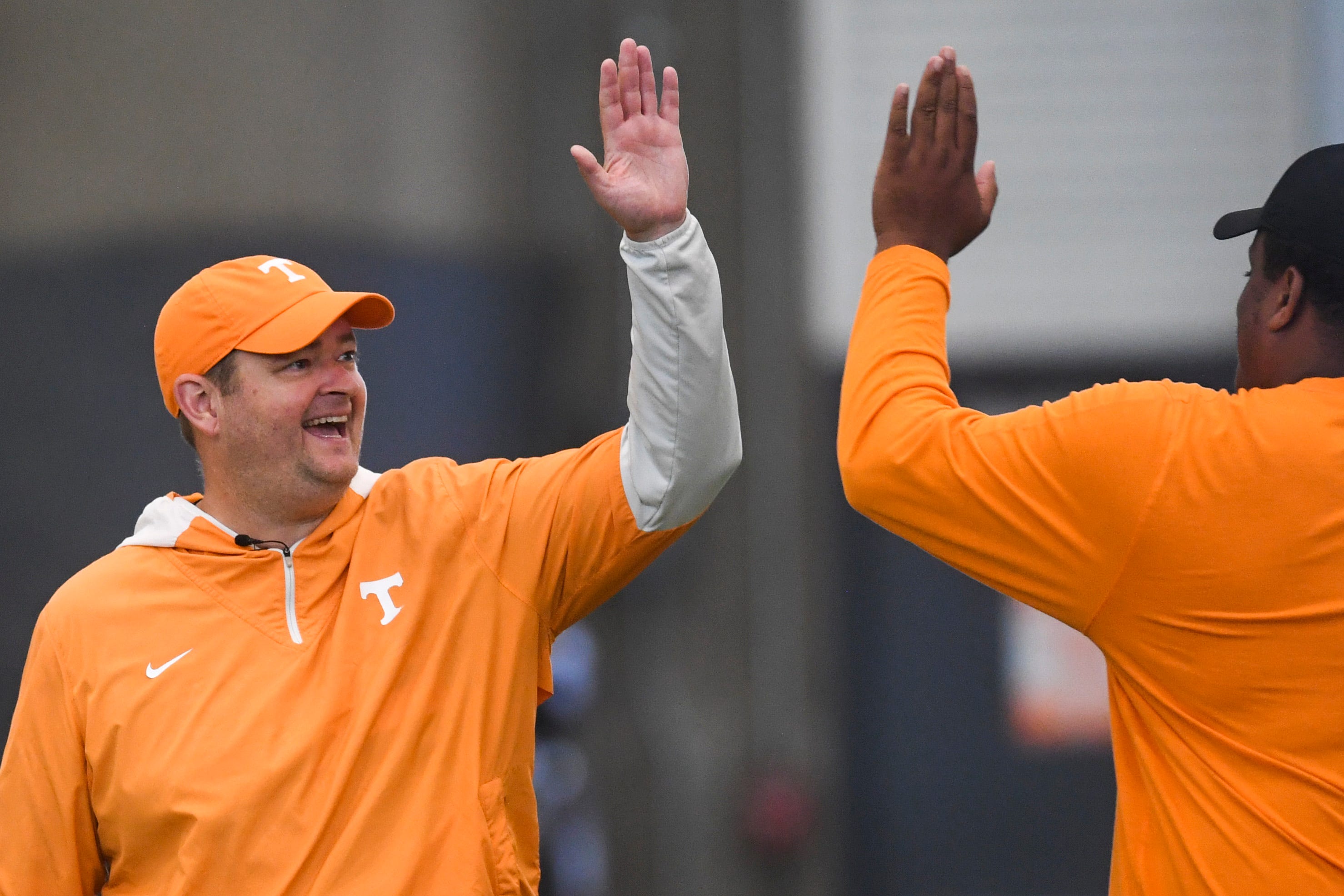 Tennessee head football coach Josh Heupel high fives an assistant during a Tennessee Football fall practice, Friday, Aug. 4, 2023.