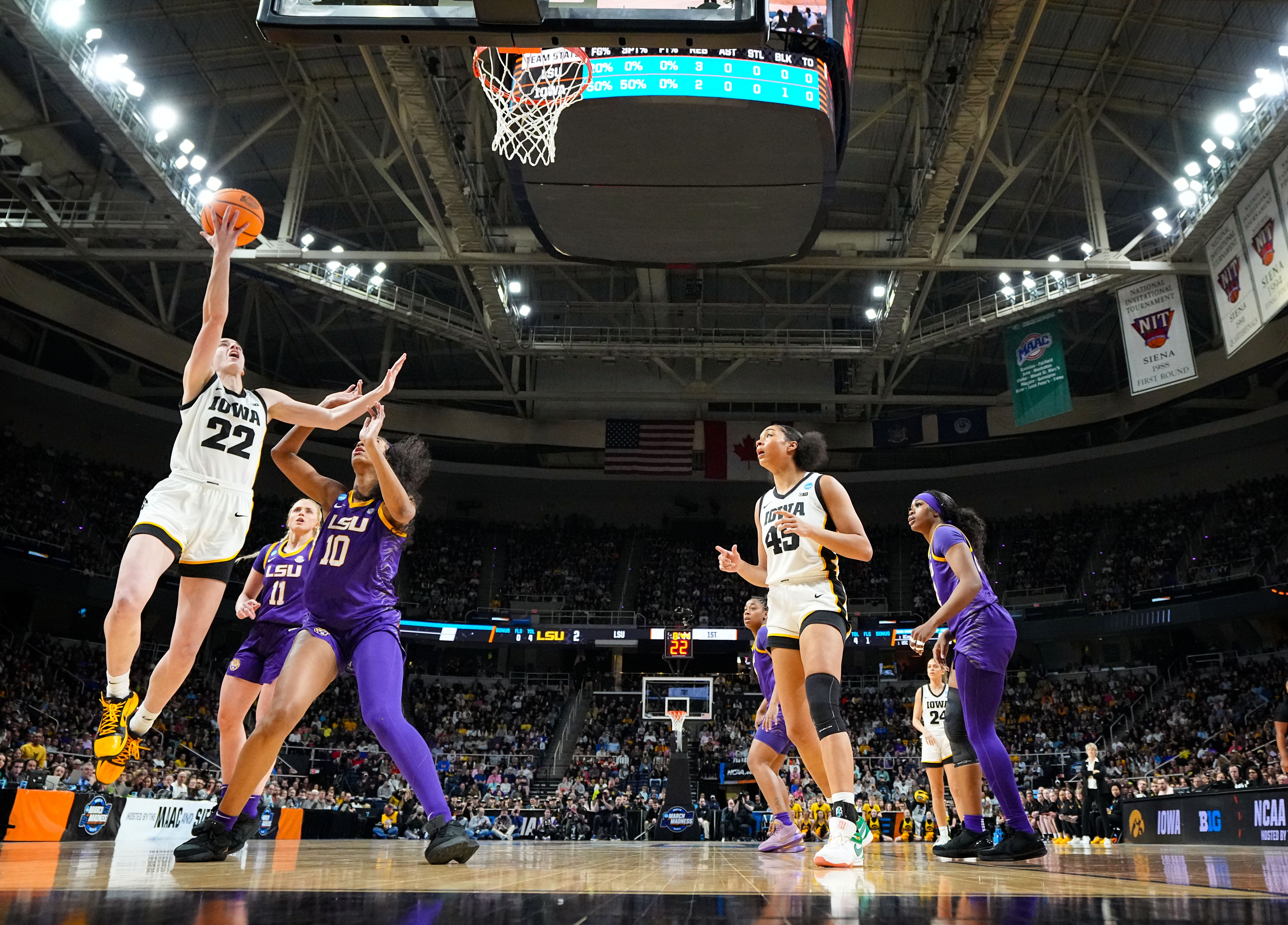 Iowa Hawkeyes guard Caitlin Clark (22) drives to the basket as LSU Lady Tigers forward Angel Reese (10) defends during the Elite 8 round of the NCAA Women's Basketball Tournament between Iowa and LSU at MVP Arena,