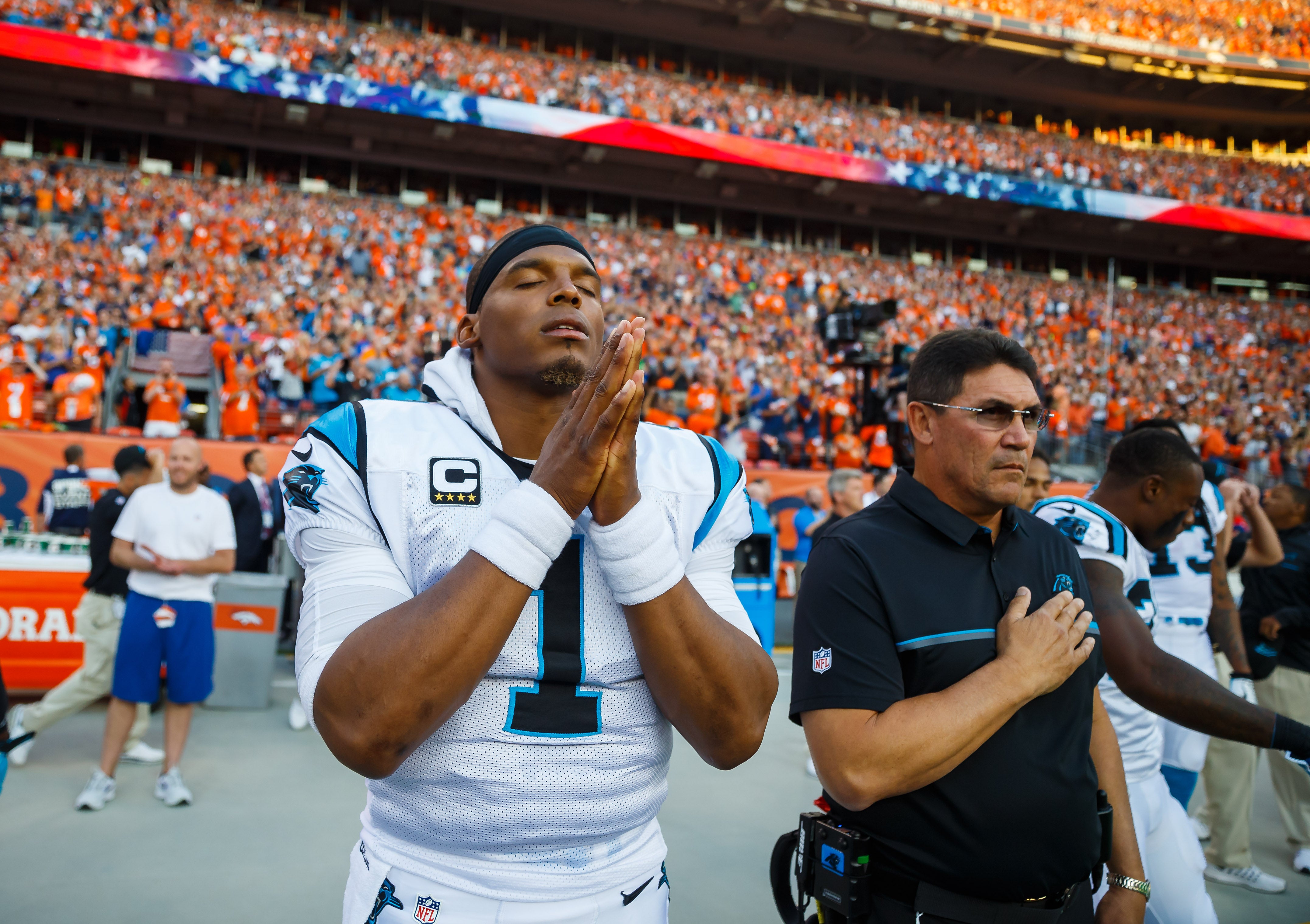 Sep 8, 2016; Denver, CO, USA; Carolina Panthers quarterback Cam Newton (1) and head coach Ron Rivera during the national anthem prior to the game against the Denver Broncos at Sports Authority Field at Mile High. The Broncos defeated the Panthers 21-20. Mandatory Credit: Mark J. Rebilas-USA TODAY Sports