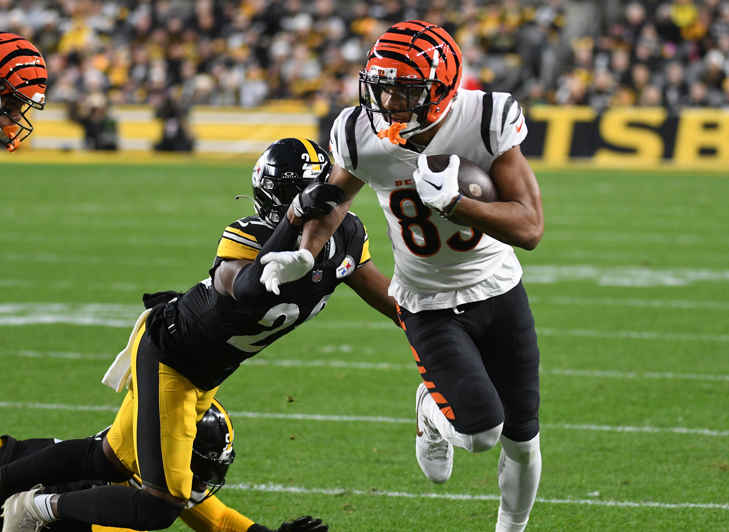 Dec 23, 2023; Pittsburgh, Pennsylvania, USA; Cincinnati Bengals wide receiver Tyler Boyd (83) is slowed down by Pittsburgh Steelers cornerback Levi Wallace (29) during the first quarter at Acrisure Stadium. Mandatory Credit: