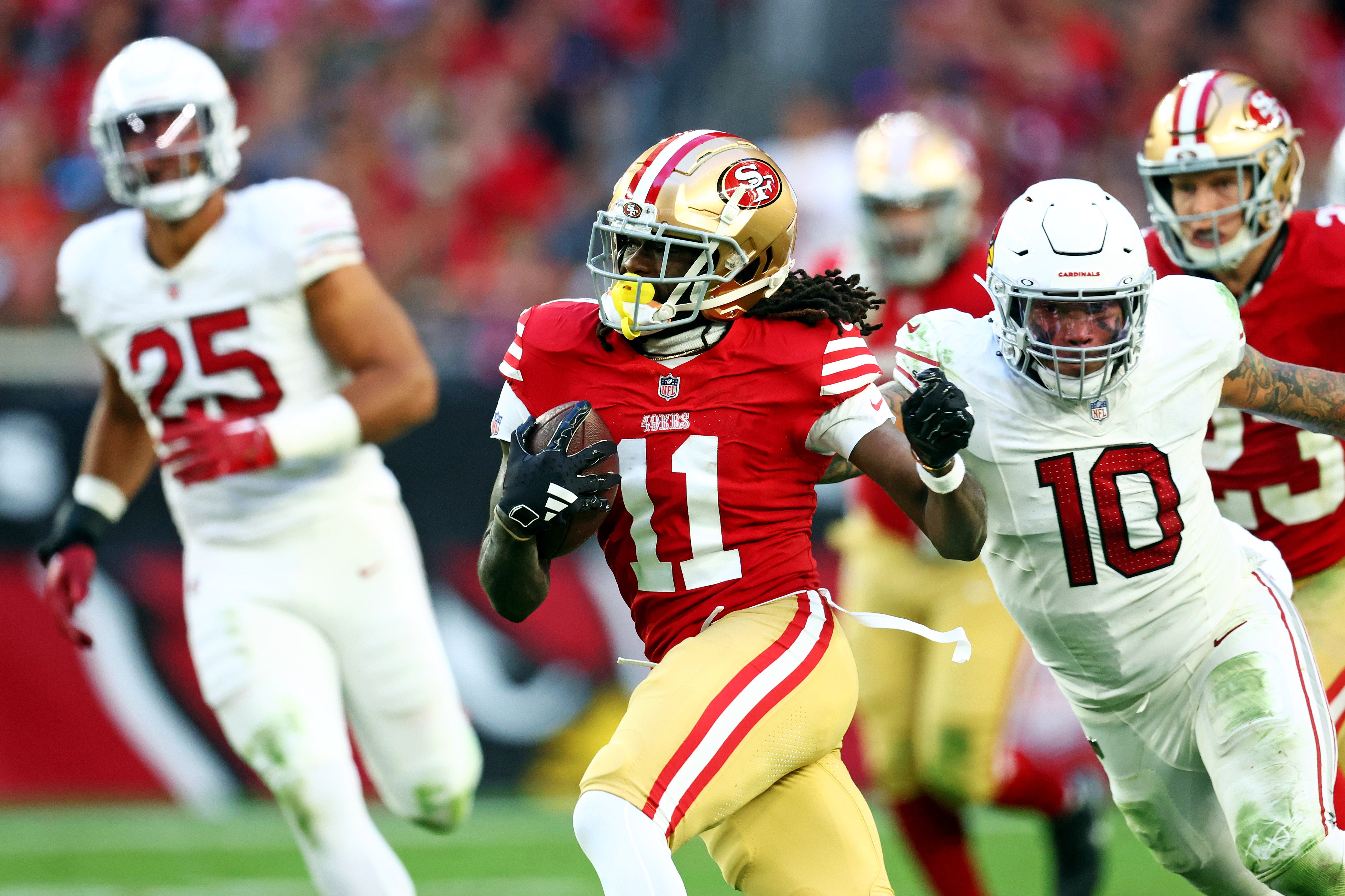 Dec 17, 2023; Glendale, Arizona, USA; San Francisco 49ers wide receiver Brandon Aiyuk (11) runs the ball against the Arizona Cardinals during the second half at State Farm Stadium.