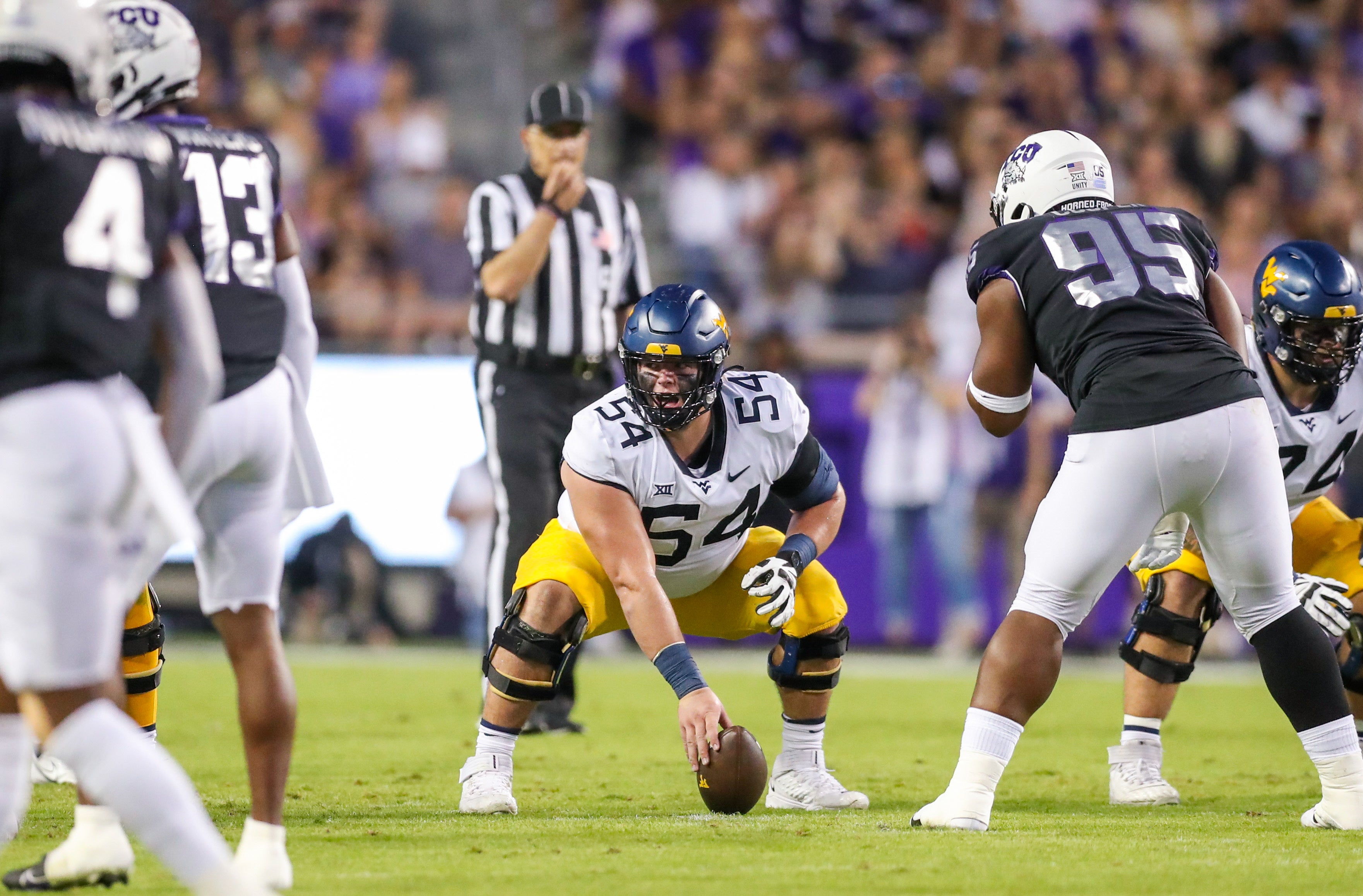 Oct 23, 2021; Fort Worth, Texas, USA; West Virginia Mountaineers offensive lineman Zach Frazier (54) during the first quarter against the TCU Horned Frogs at Amon G. Carter Stadium. Mandatory Credit: Ben Queen-USA TODAY Sports