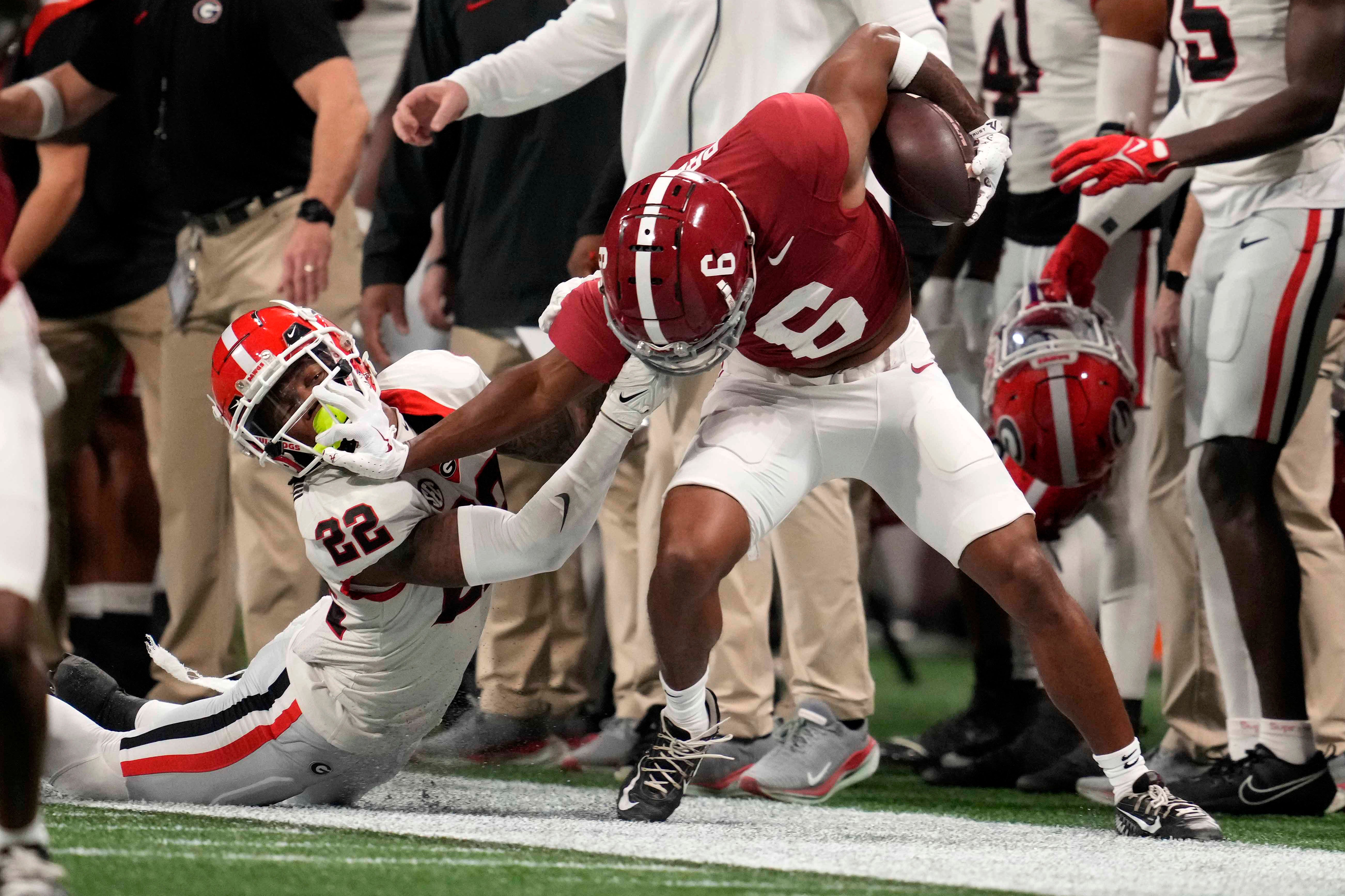 Dec 2, 2023; Atlanta, GA, USA; Alabama Crimson Tide wide receiver Kobe Prentice (6) attempts to break the tackle of Georgia Bulldogs defensive back Javon Bullard (22) during the first half in the SEC Championship game at Mercedes-Benz Stadium.