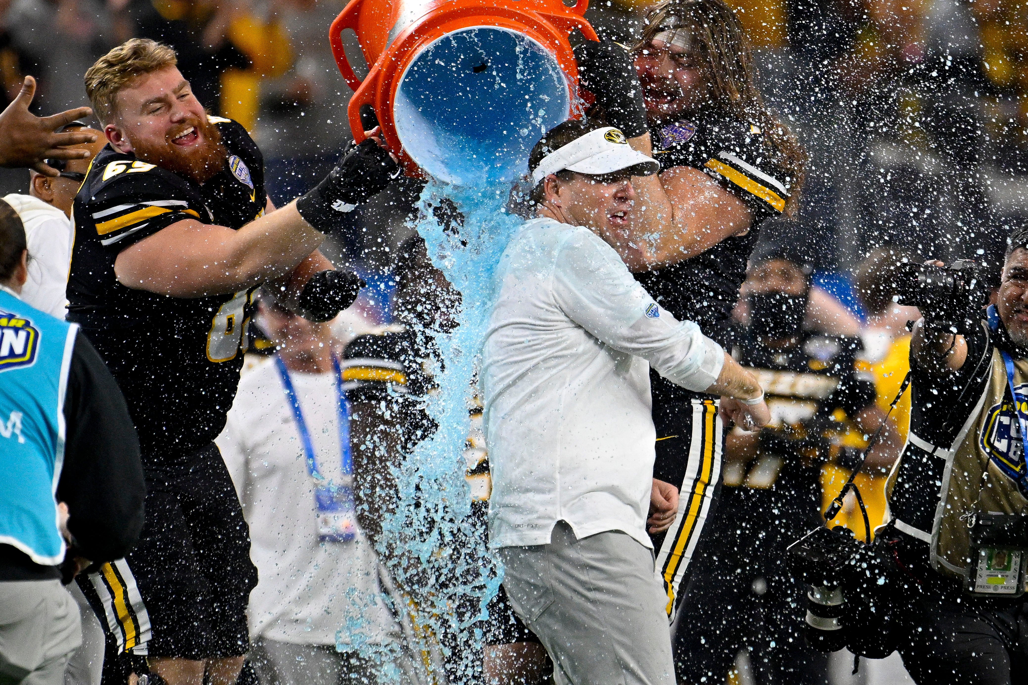 Dec 29, 2023; Arlington, TX, USA; Missouri Tigers head coach Eliah Drinkwitz is doused with Gatorade after the Tigers defeat the Ohio State Buckeyes at AT&T Stadium. Mandatory Credit: Jerome Miron-USA TODAY Sports