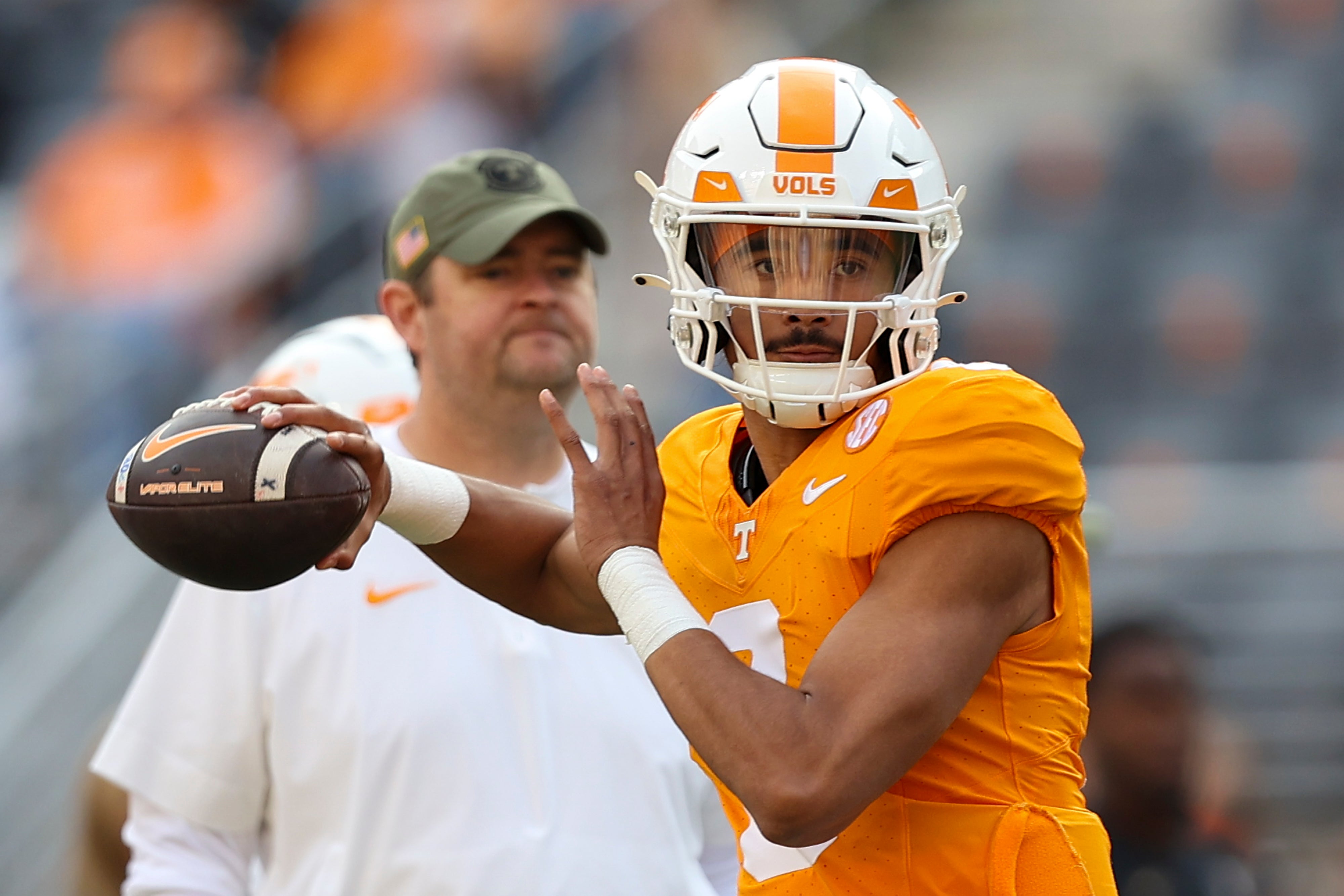 Nov 25, 2023; Knoxville, Tennessee, USA; Tennessee Volunteers quarterback Nico Iamaleava (8) warms up as head coach Josh Heupel looks on before the game against the Vanderbilt Commodores at Neyland Stadium.