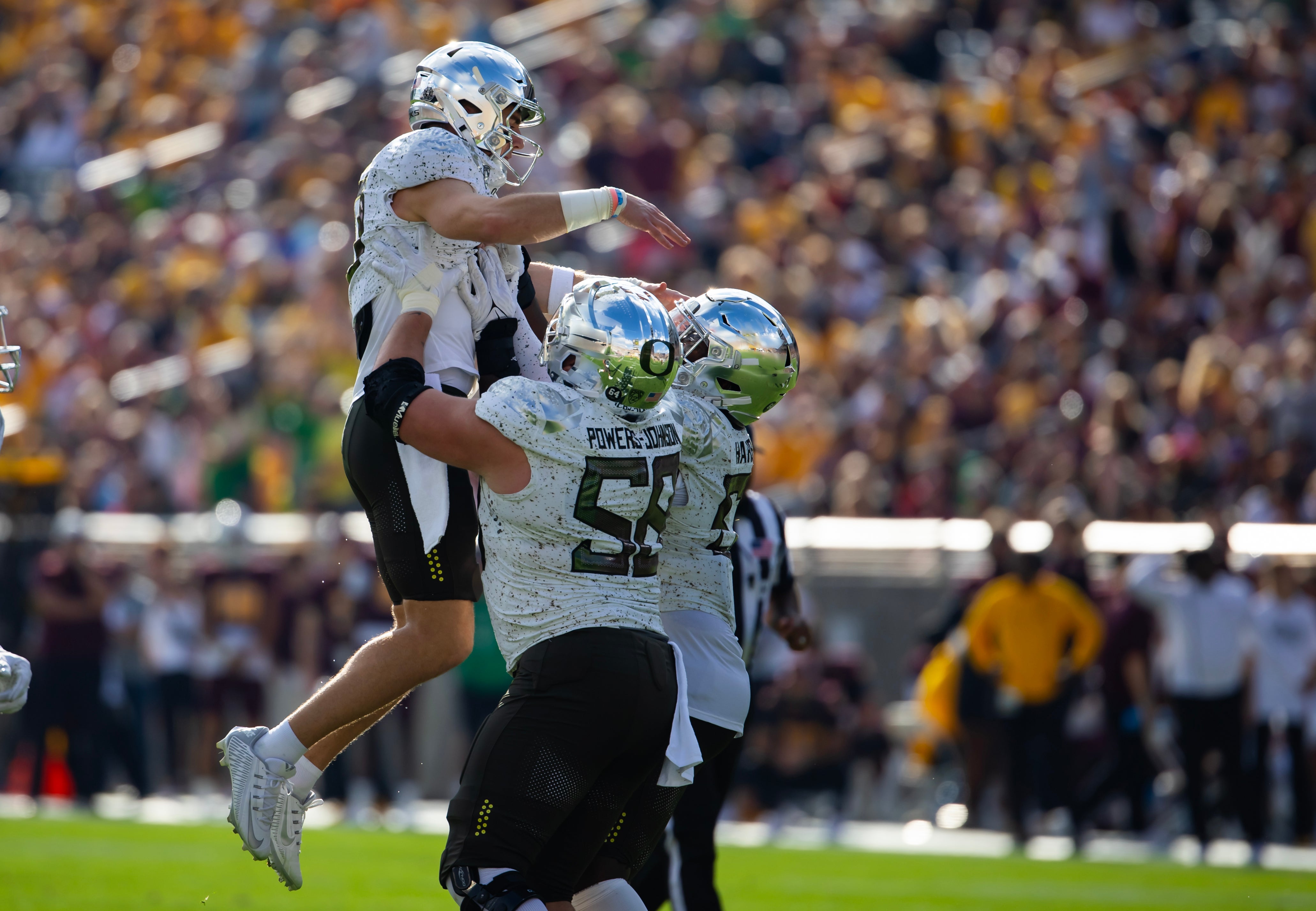 Nov 18, 2023; Tempe, Arizona, USA; Oregon Ducks quarterback Bo Nix (10) is hoisted in the air as he celebrates a touchdown with offensive lineman Jackson Powers-Johnson (58) against the Arizona State Sun Devils in the first half at Mountain America Stadium.