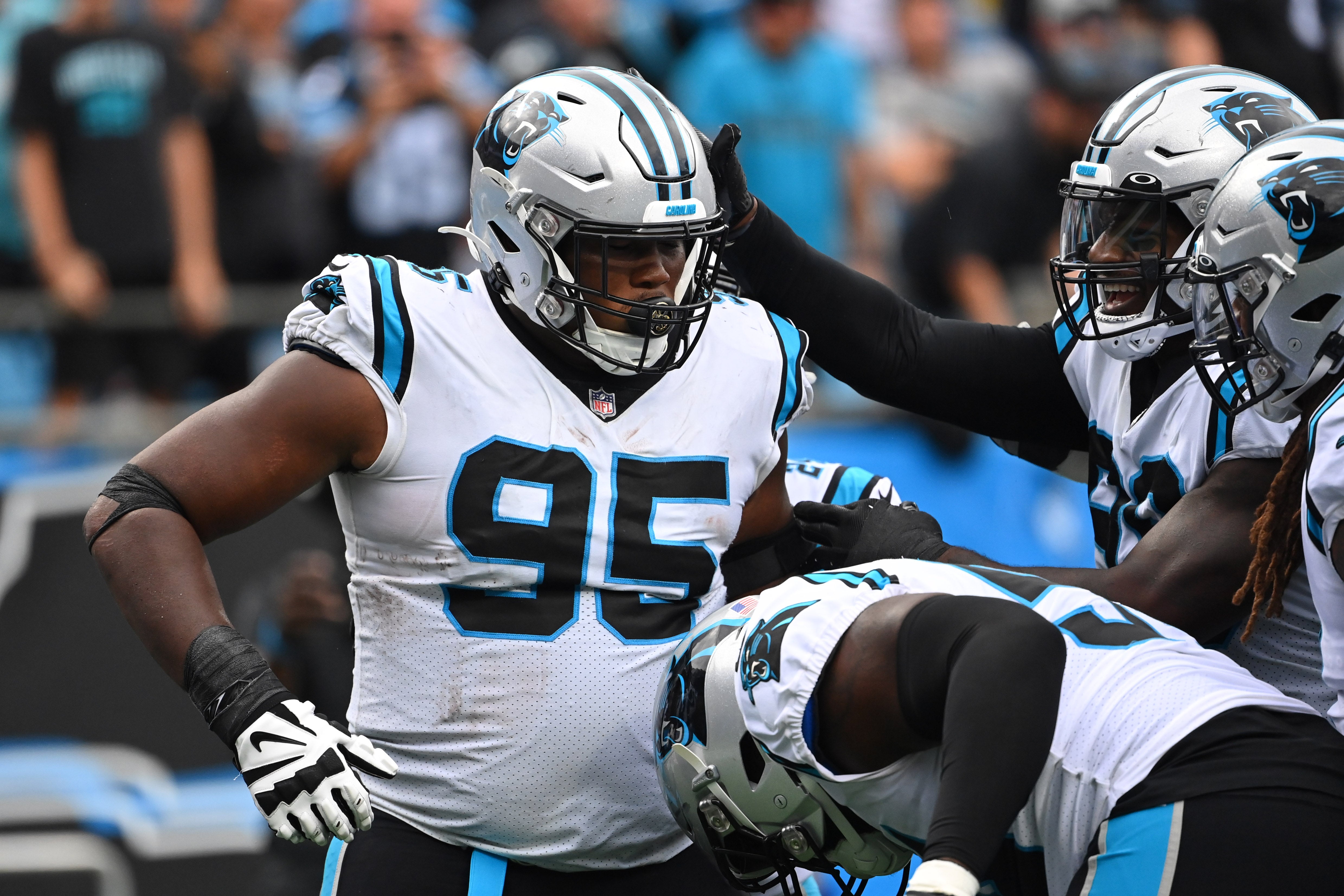 Sep 25, 2022; Charlotte, North Carolina, USA; Carolina Panthers defensive tackle Derrick Brown (95) celebrates with teammates after intercepting a pass in the fourth quarter at Bank of America Stadium. Mandatory Credit: Bob Donnan-USA TODAY Sports