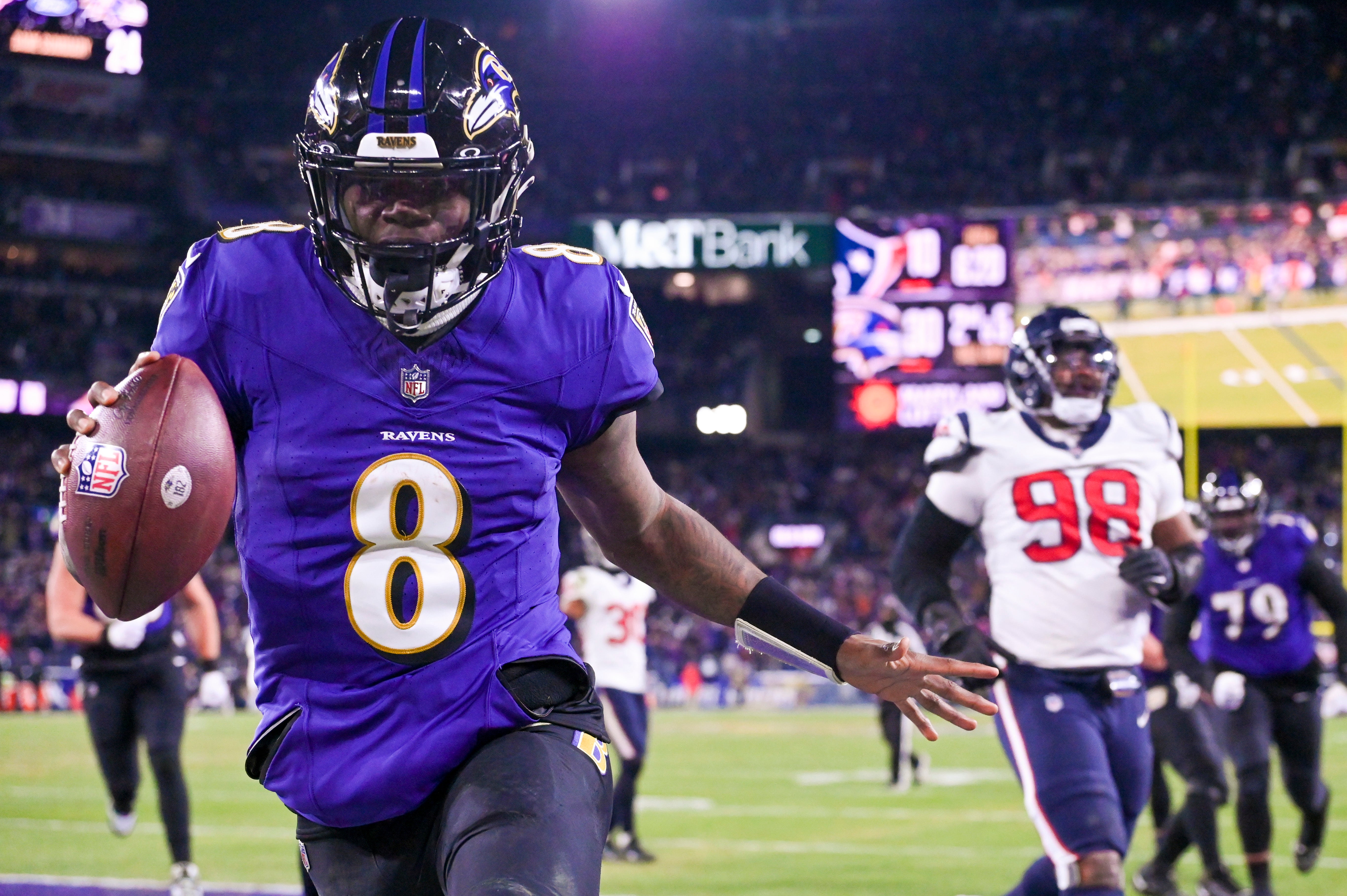 Jan 20, 2024; Baltimore, MD, USA; Baltimore Ravens quarterback Lamar Jackson (8) reacts after running past for Houston Texans defensive tackle Sheldon Rankins (98) for a touchdown during the fourth quarter in a 2024 AFC divisional round game at M&T Bank Stadium. Mandatory Credit: Tommy Gilligan-USA TODAY Sports