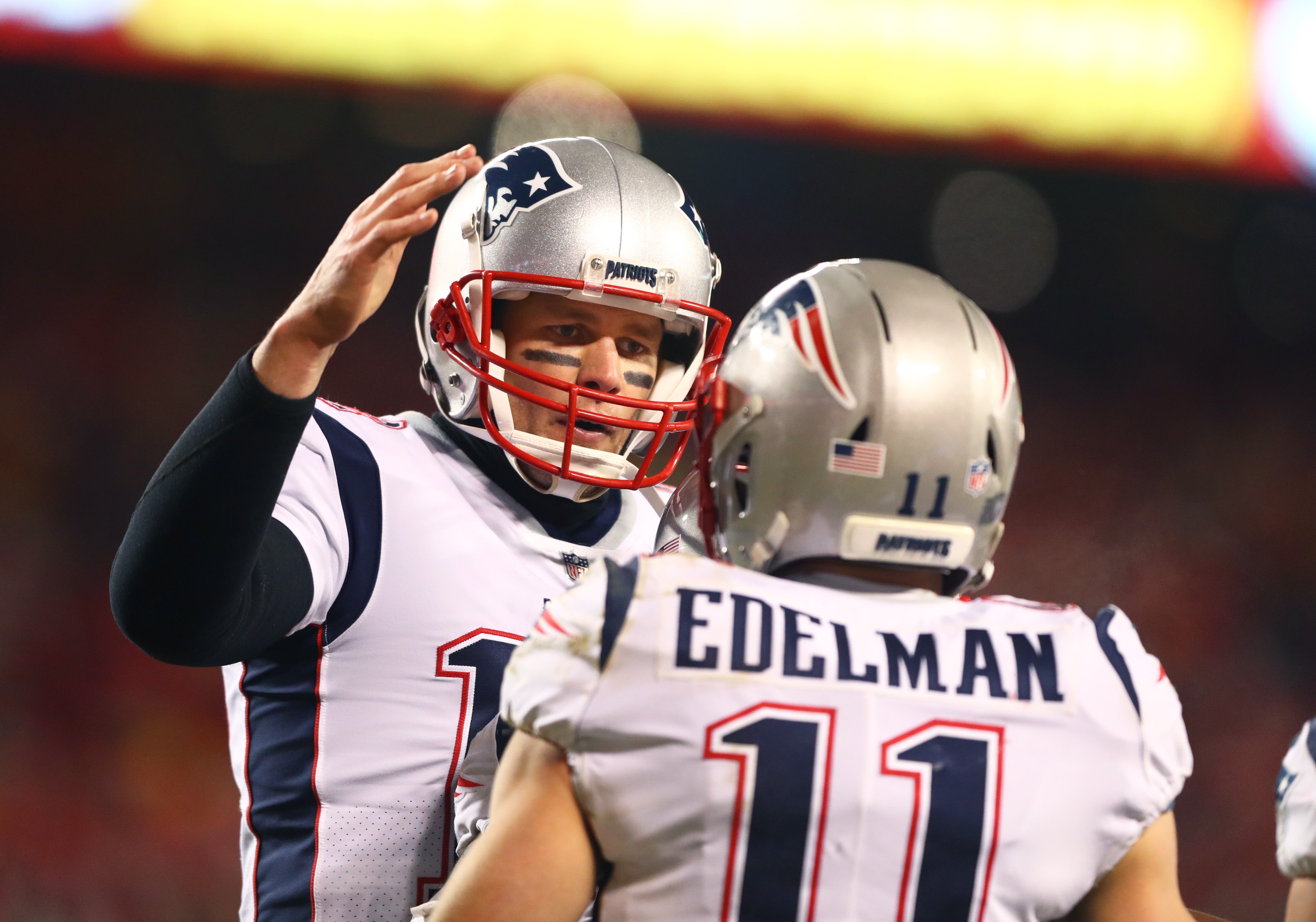 Jan 20, 2019; Kansas City, MO, USA; New England Patriots quarterback Tom Brady (12) celebrates a touchdown with wide receiver Julian Edelman (11) against the Kansas City Chiefs in the AFC Championship game at Arrowhead Stadium.