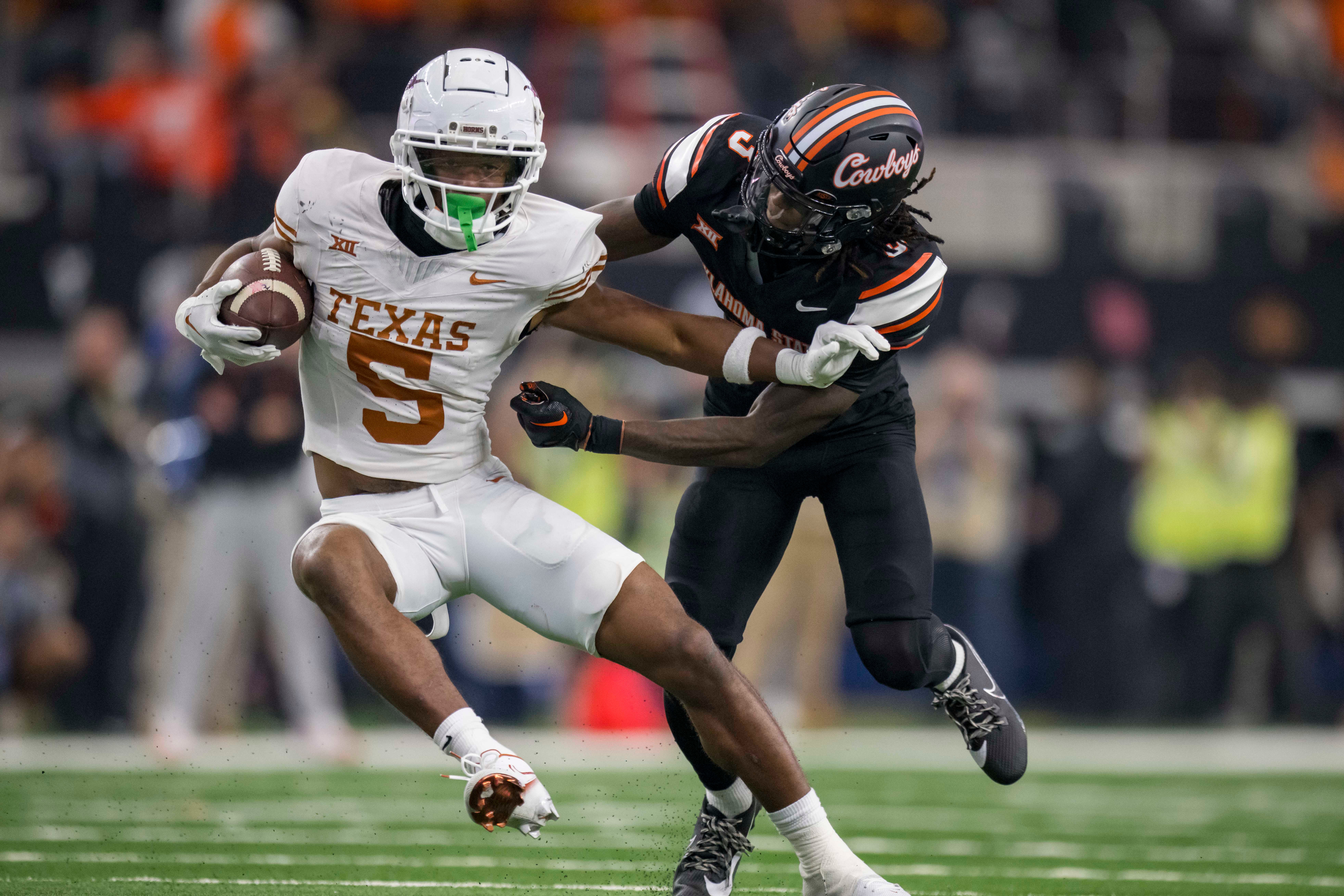 Dec 2, 2023; Arlington, TX, USA; Texas Longhorns wide receiver Adonai Mitchell (5) and Oklahoma State Cowboys cornerback Cam Smith (3) in action during the game between the Texas Longhorns and the Oklahoma State Cowboys at AT&T Stadium. Mandatory Credit: Jerome Miron-USA TODAY Sports