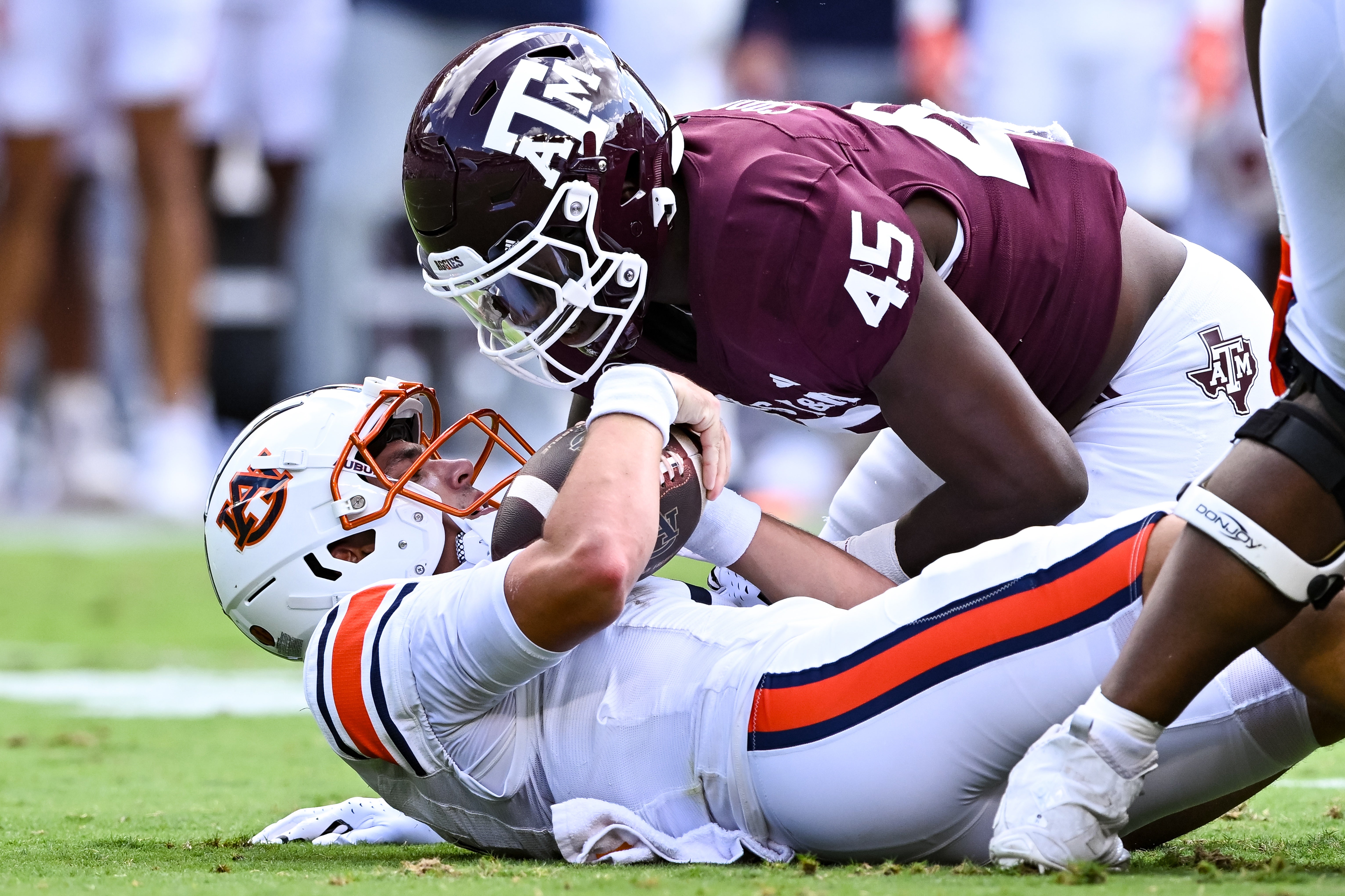 Texas A&M Aggies linebacker Edgerrin Cooper (45) sacks Auburn Tigers quarterback Payton Thorne (1) during the first quarter at Kyle Field.