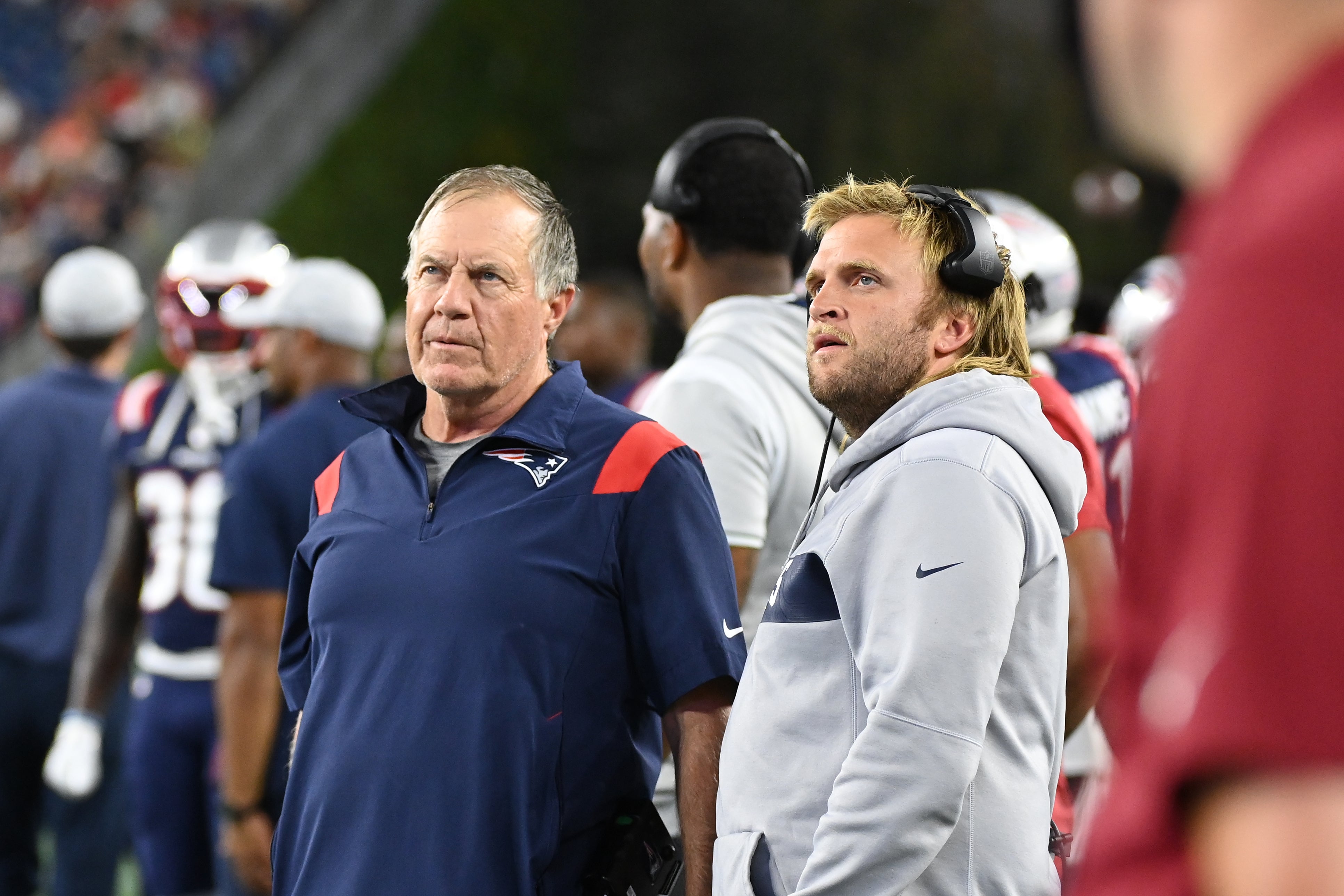 Aug 19, 2022; Foxborough, Massachusetts, USA; New England Patriots head coach Bill Belichick (left) and Steve Belichick, linebackers coach (right) watch the in stadium displays during the first half of a preseason against the Carolina Panthers game at Gillette Stadium. 