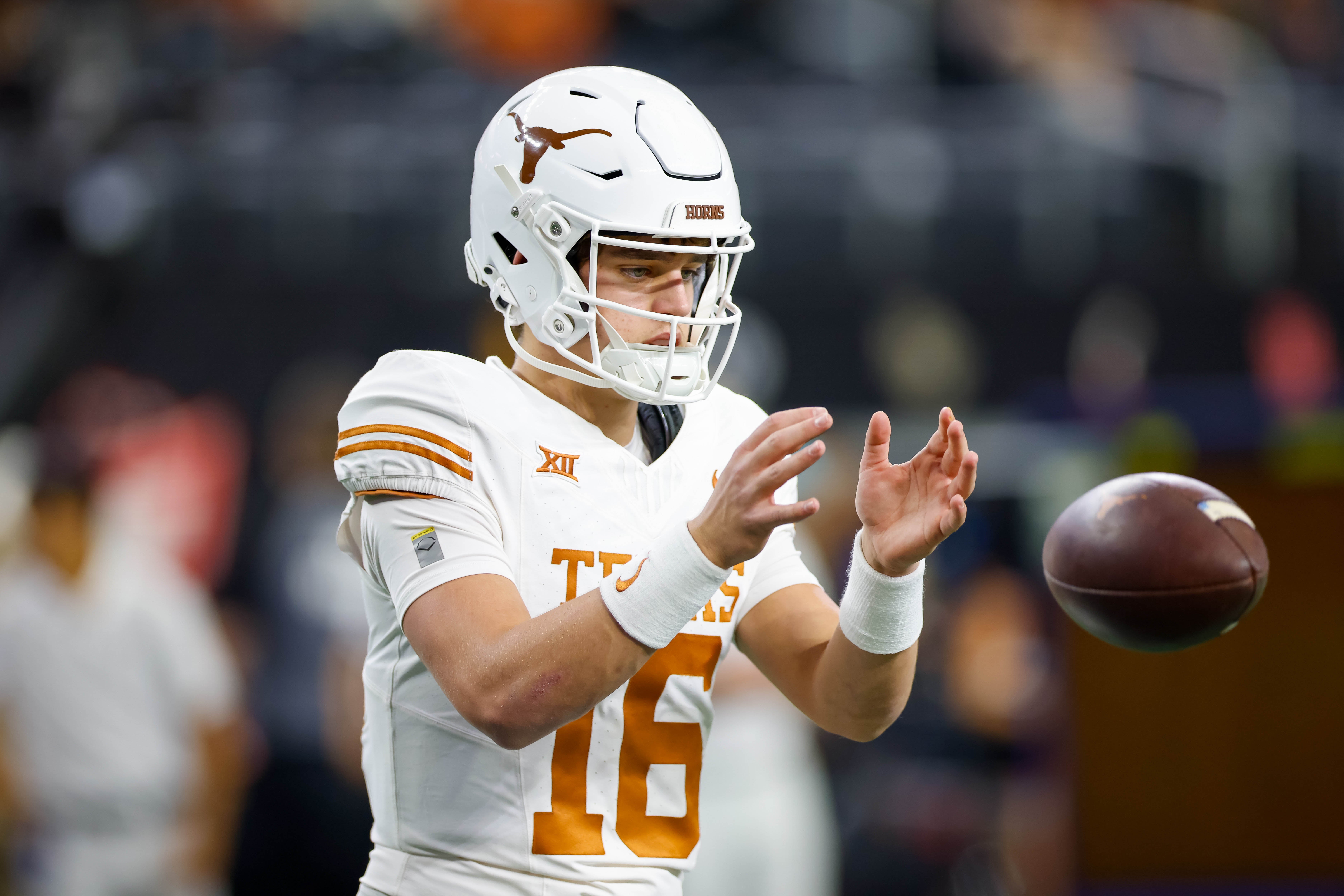 Texas Longhorns quarterback Arch Manning (16) warms up prior to the game against the Oklahoma State Cowboys at AT&T Stadium.