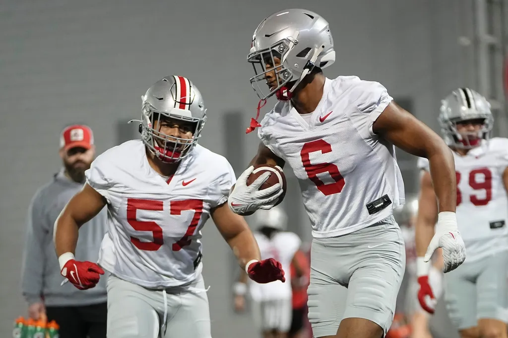 Ohio State Buckeyes safety Sonny Styles (6) runs past linebacker Jalen Pace (57) during spring football practice at the Woody Hayes Athletic Center