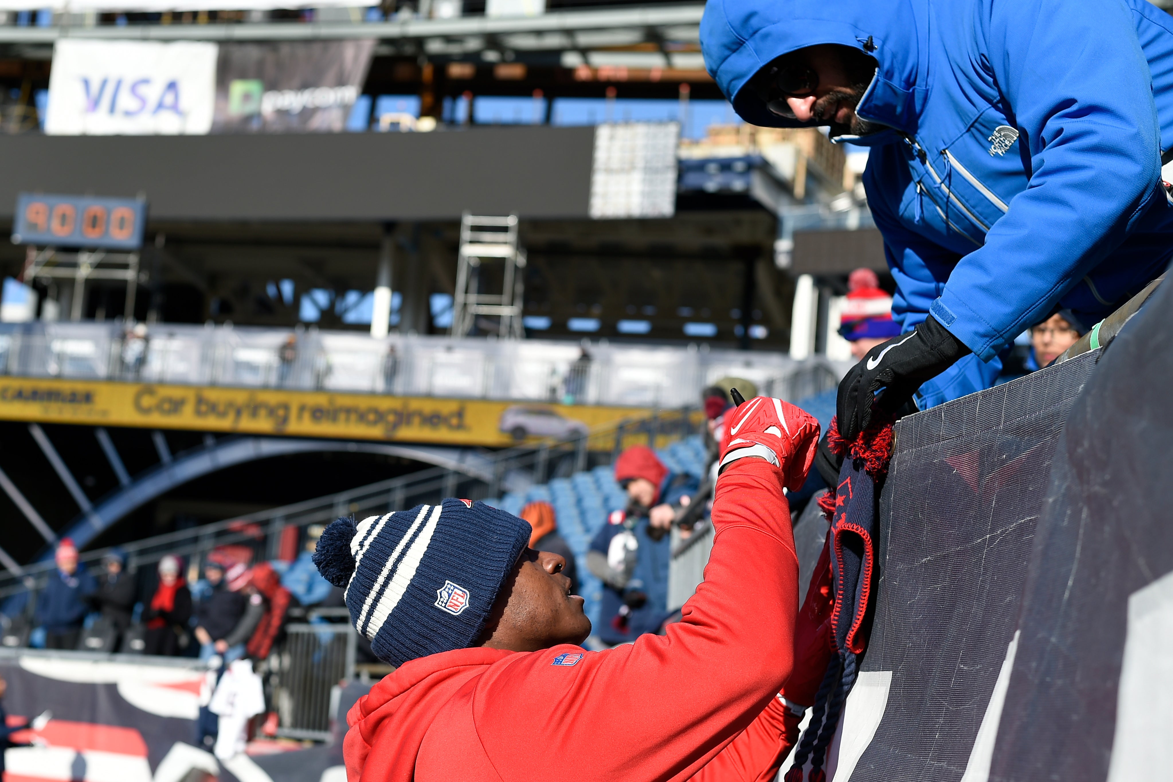 Dec 24, 2022; Foxborough, Massachusetts, USA; New England Patriots wide receiver Matthew Slater (18) signs an autograph for a fan before a game against the Cincinnati Bengals at Gillette Stadium.