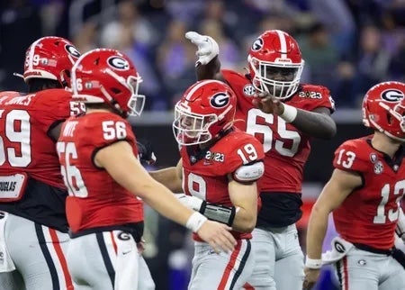 Georgia Bulldogs tight end Brock Bowers (19) celebrates a touchdown with offensive lineman Amarius Mims (65) against the TCU Horned Frogs during the CFP national championship game at SoFi Stadium.