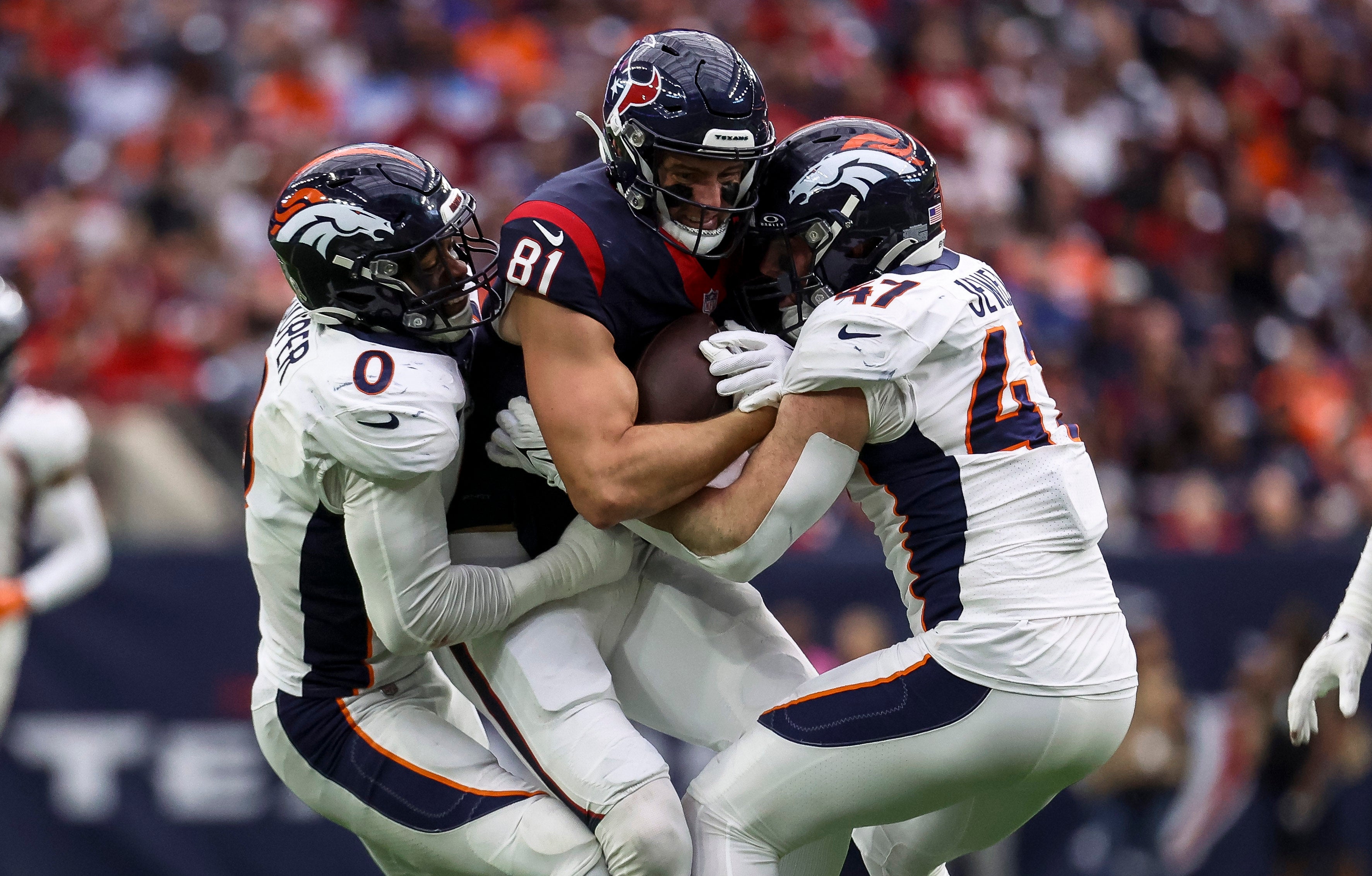 Dec 3, 2023; Houston, Texas, USA; Houston Texans tight end Eric Saubert (81) runs with the ball after a reception as Denver Broncos linebacker Jonathon Cooper (0) and Denver Broncos linebacker Josey Jewell (47) attempt to make a tackle during the third quarter at NRG Stadium.