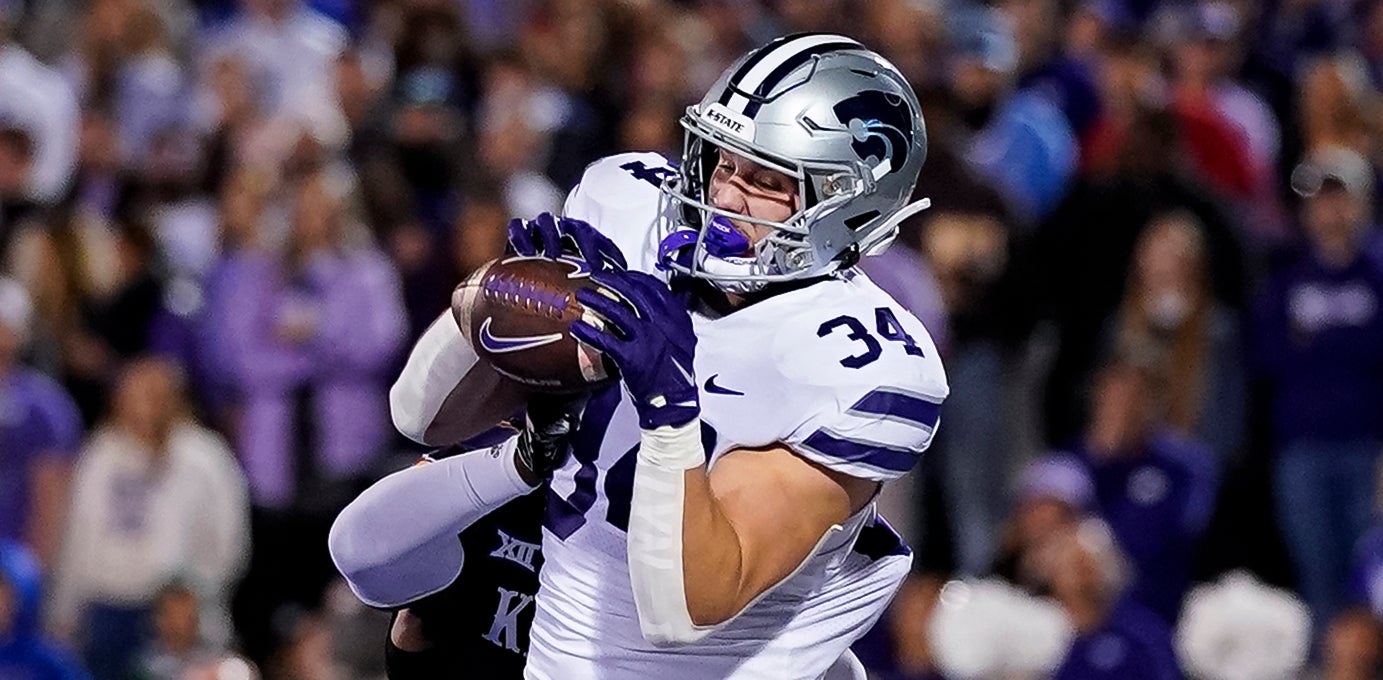 Nov 18, 2023; Lawrence, Kansas, USA; Kansas State Wildcats tight end Ben Sinnott (34) catches a touchdown pass against Kansas Jayhawks safety Marvin Grant (4) during the first half at David Booth Kansas Memorial Stadium.