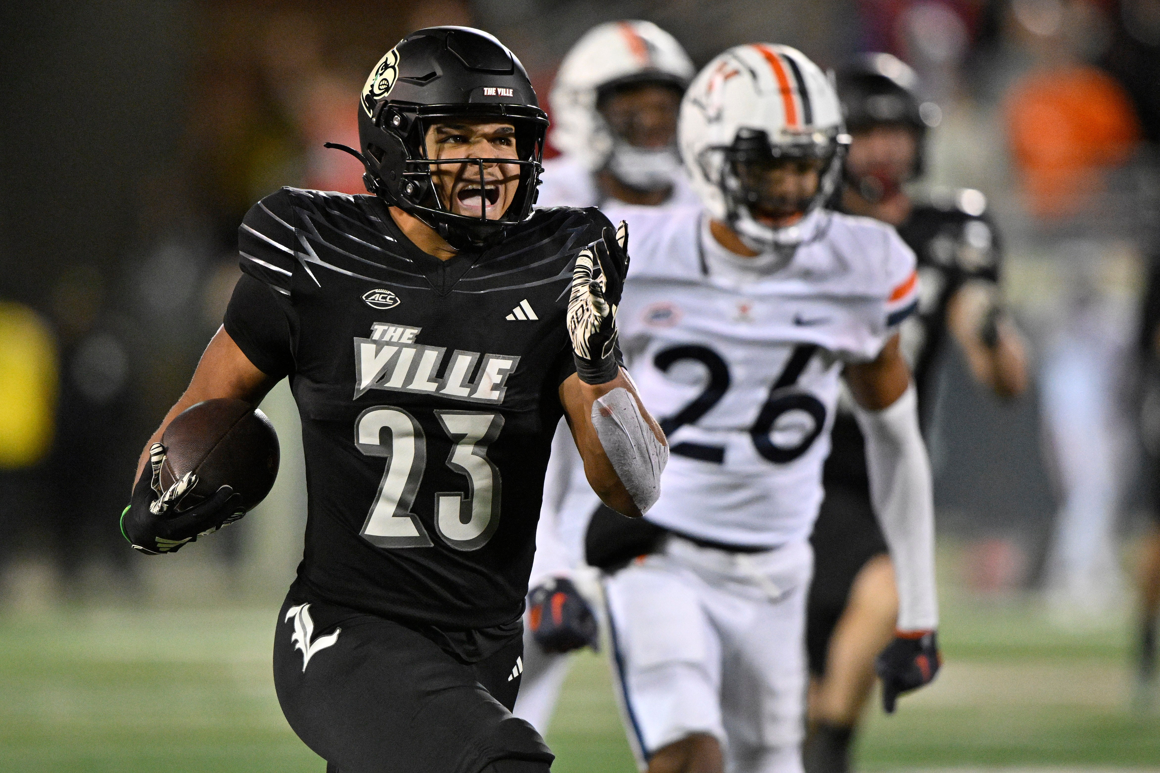 Nov 9, 2023; Louisville, Kentucky, USA; Louisville Cardinals running back Isaac Guerendo (23) runs the ball against the Virginia Cavaliers to score a touchdown during the second half at L&N Federal Credit Union Stadium. Louisville defeated Virginia 31-24.