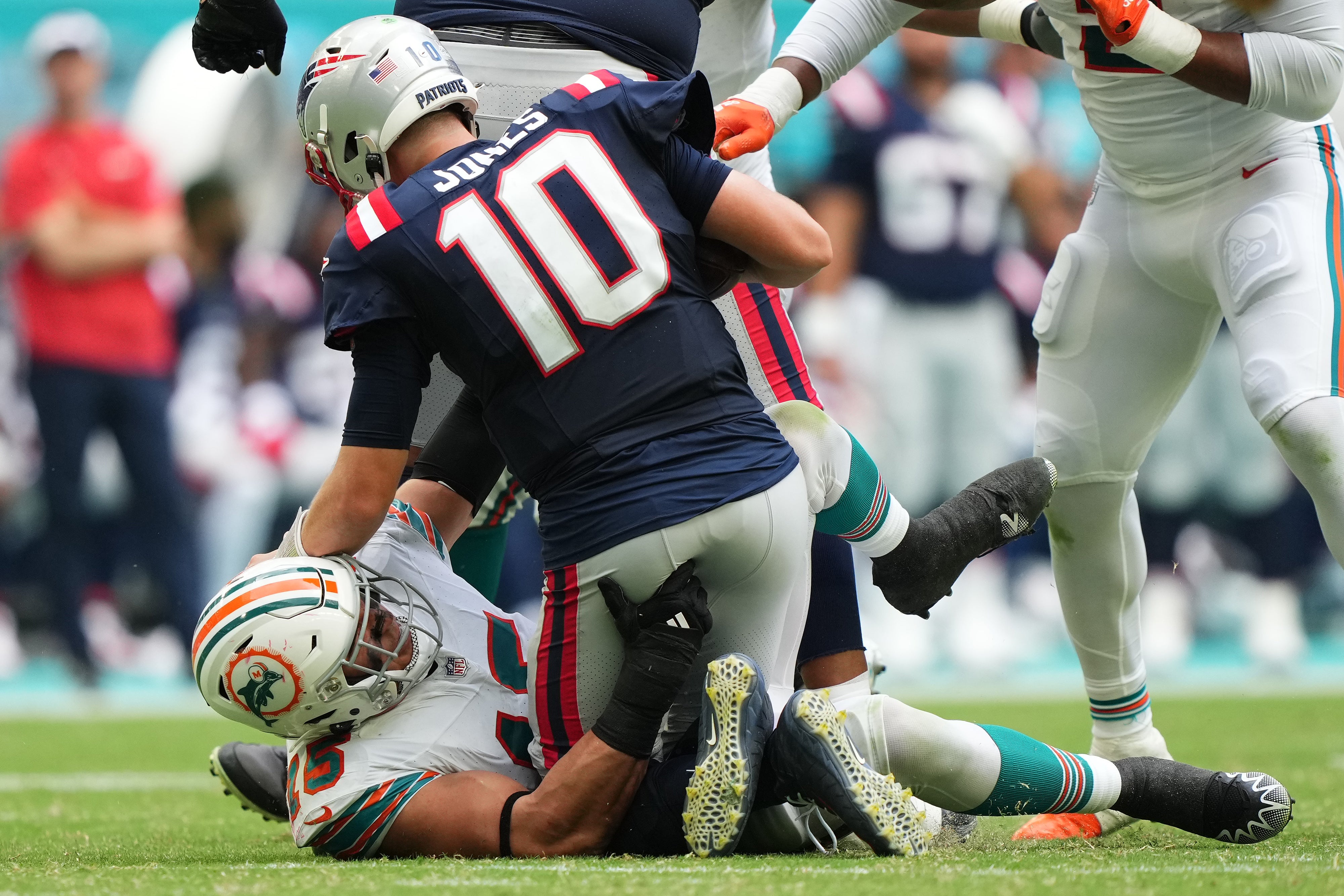 Oct 29, 2023; Miami Gardens, Florida, USA; Miami Dolphins linebacker Jaelan Phillips (15) sacks New England Patriots quarterback Mac Jones (10) during the second half at Hard Rock Stadium.