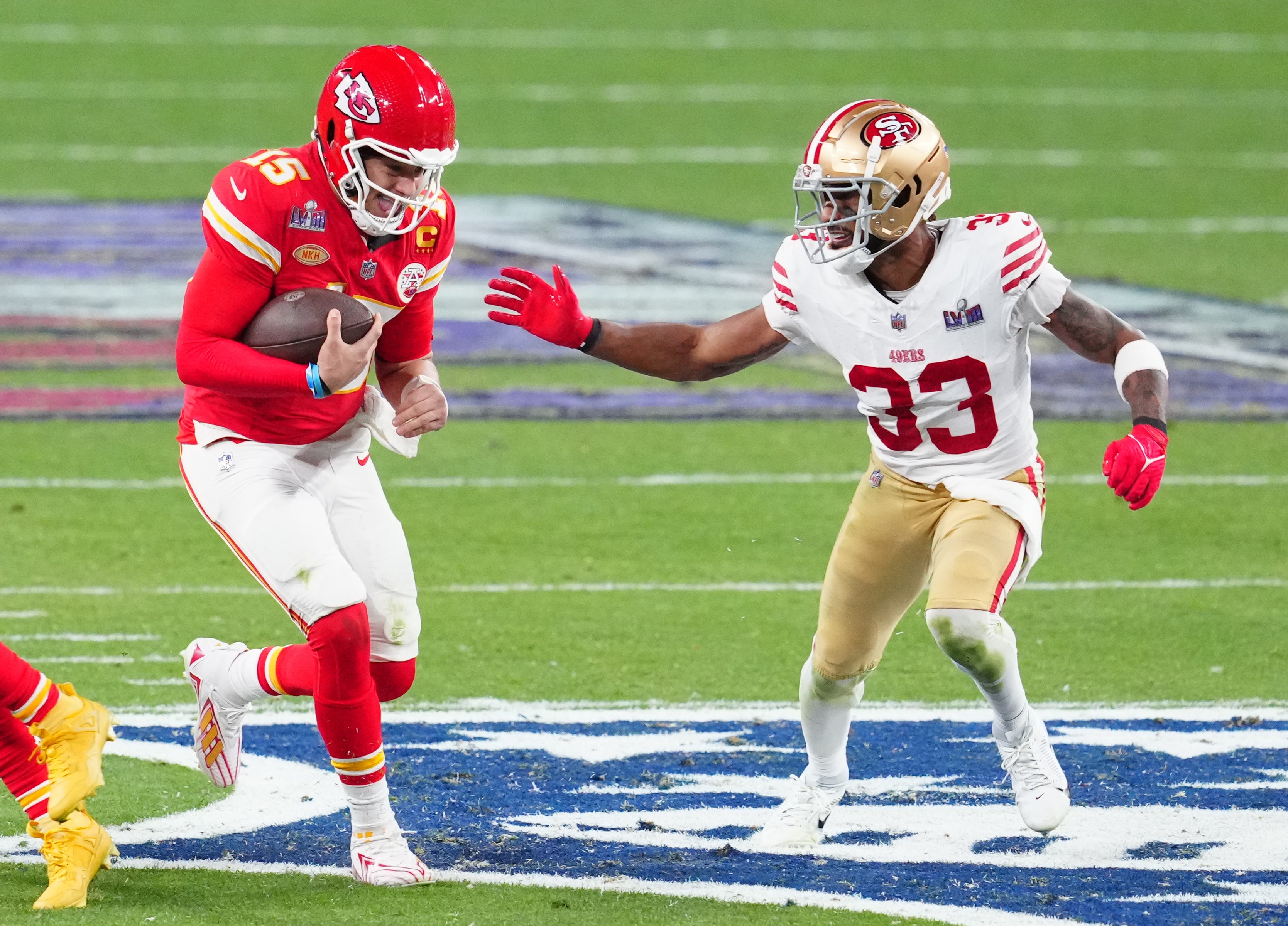 Feb 11, 2024; Paradise, Nevada, USA; Kansas City Chiefs quarterback Patrick Mahomes (15) is chased by San Francisco 49ers safety Logan Ryan (33) in the second half in Super Bowl LVIII at Allegiant Stadium.