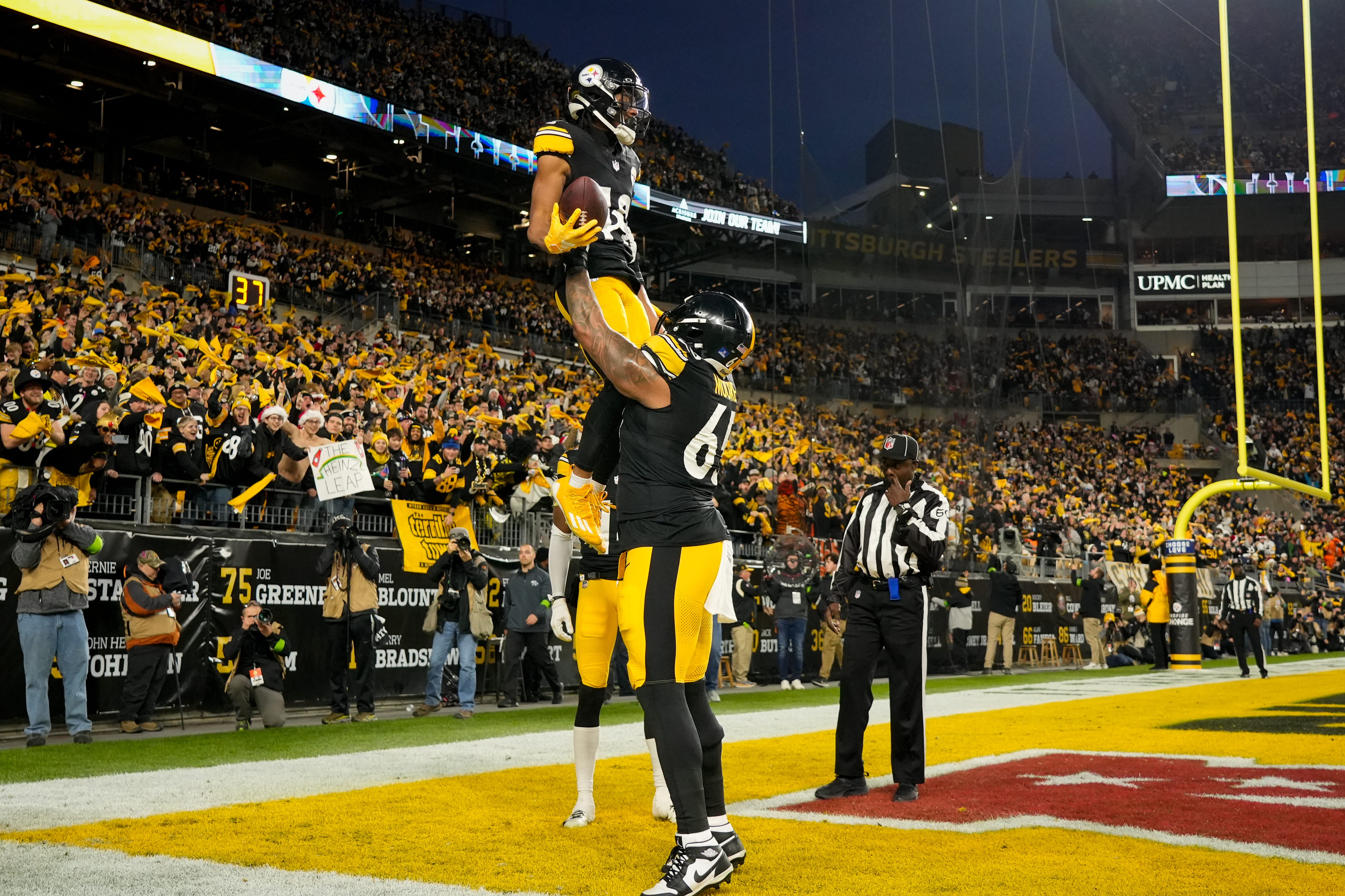 Pittsburgh Steelers offensive tackle Dan Moore Jr. (65) lifts wide receiver Calvin Austin III (19) as they celebrate a touchdown in the second quarter of the NFL 16 game between the Pittsburgh Steelers and the Cincinnati Bengals at Acrisure Stadium in Pittsburgh on Saturday, Dec. 23, 2023. The Steelers led 24-0 at halftime.