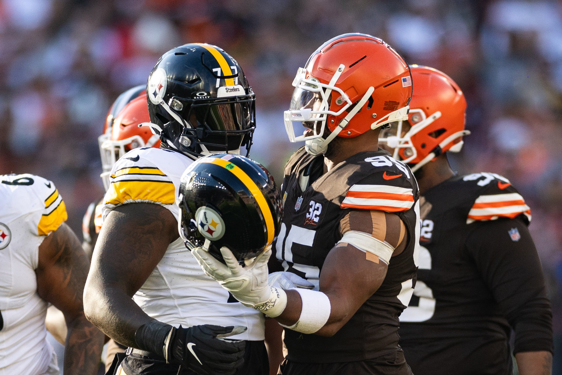 Nov 19, 2023; Cleveland, Ohio, USA; Cleveland Browns defensive end Myles Garrett (95) hands a helmet back to Pittsburgh Steelers offensive tackle Broderick Jones (77) during the third quarter at Cleveland Browns Stadium. Mandatory Credit: Scott Galvin-USA TODAY Sports