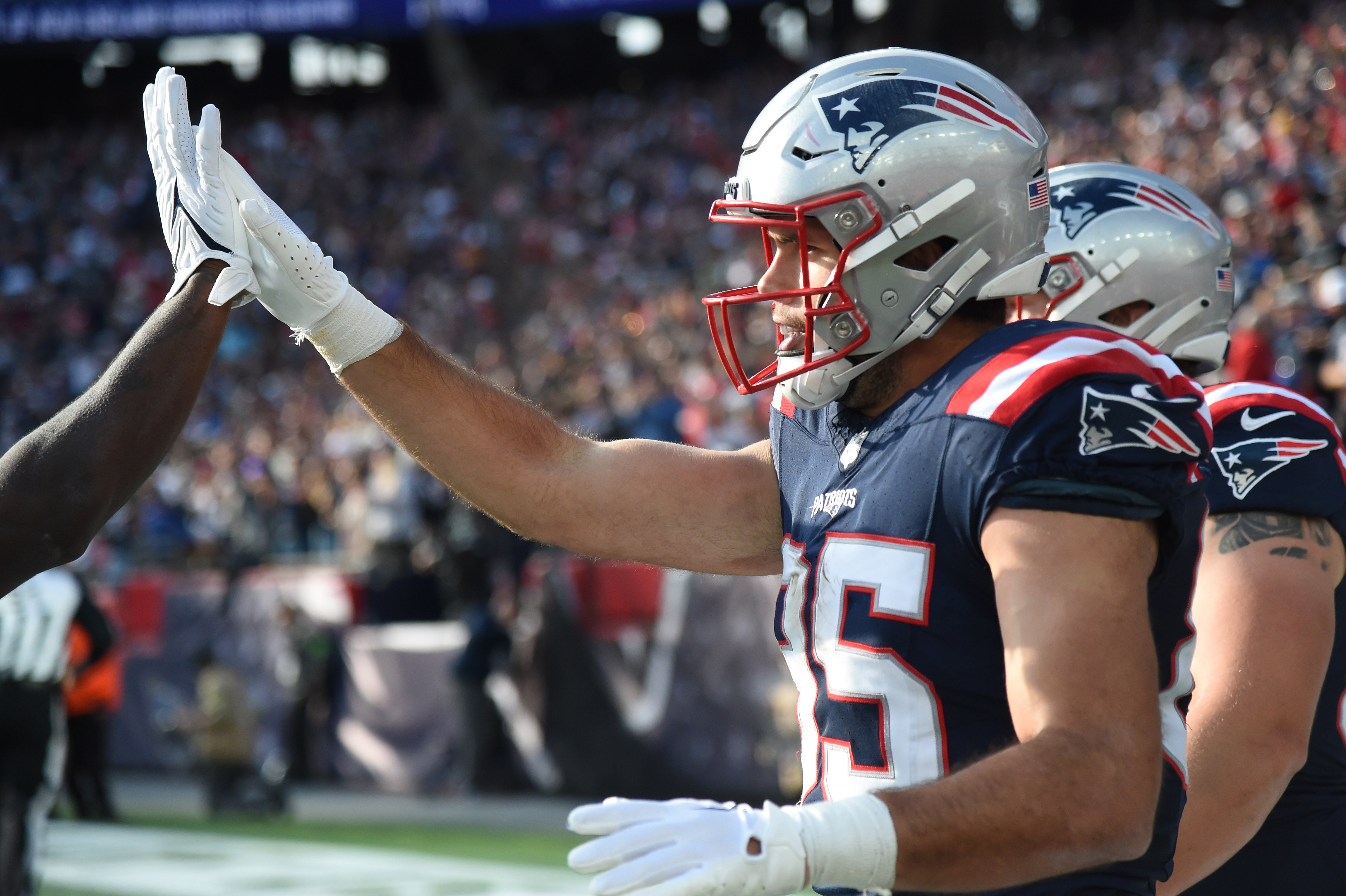Nov 5, 2023; Foxborough, Massachusetts, USA; New England Patriots tight end Hunter Henry (85) high fives a teammate after scoring a touchdown during the first half against the Washington Commanders at Gillette Stadium
