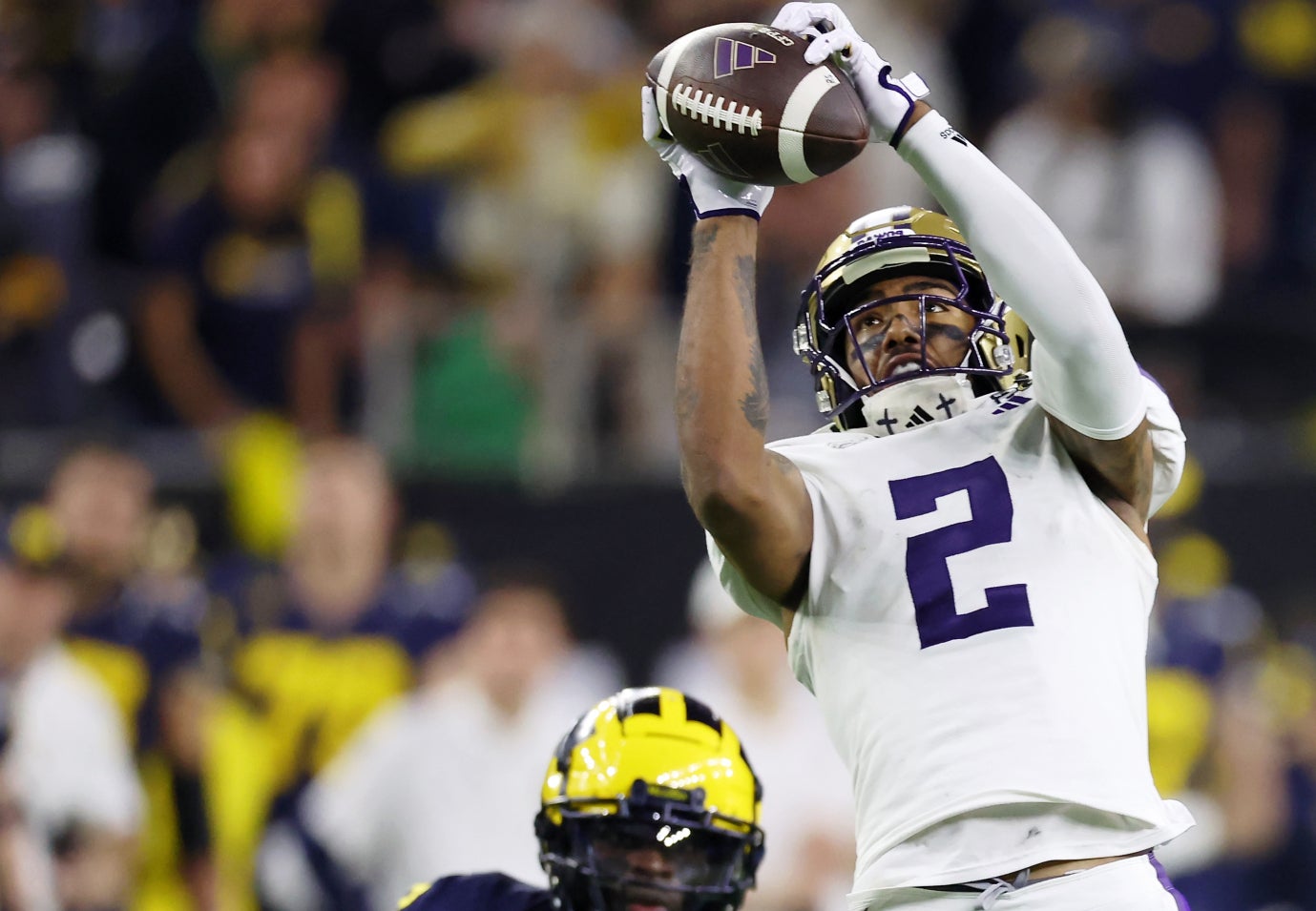 Jan 8, 2024; Houston, TX, USA; Washington Huskies wide receiver Ja'Lynn Polk (2) makes a catch against the Michigan Wolverines during the fourth quarter in the 2024 College Football Playoff national championship game at NRG Stadium.