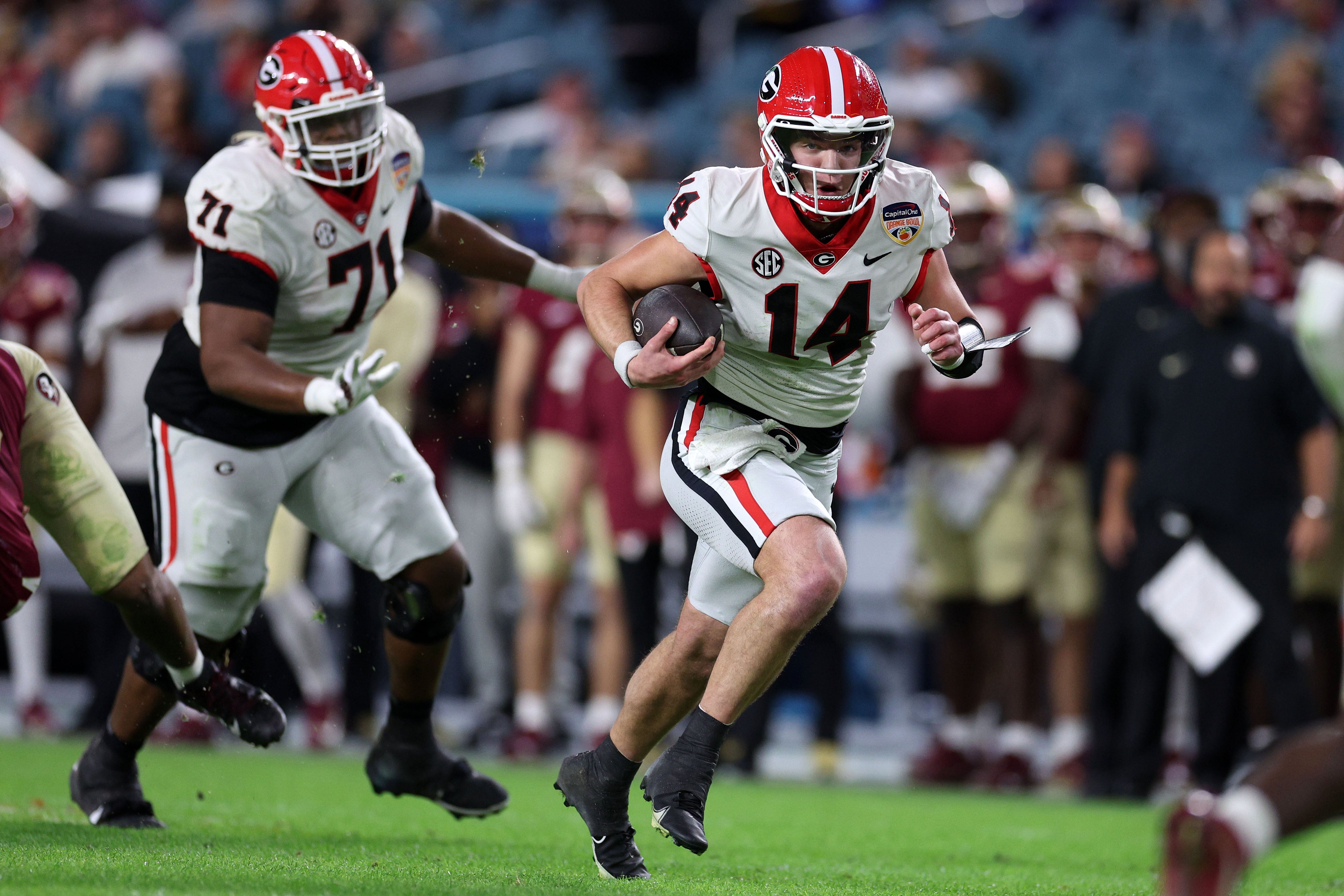 Dec 30, 2023; Miami Gardens, FL, USA; Georgia Bulldogs quarterback Gunner Stockton (14) rushes the ball against the Florida State Seminoles during the second half in the 2023 Orange Bowl at Hard Rock Stadium.