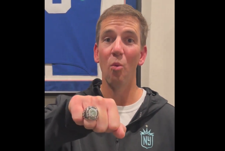 Eli Manning showing off his Gotham FC Championship Ring