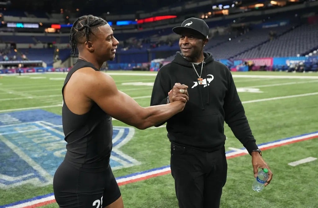 Southern California wide receiver Brenden Rice (WO25) and his father, NFL Hall of Fame player Jerry Rice during the 2024 NFL Combine at Lucas Oil Stadium.