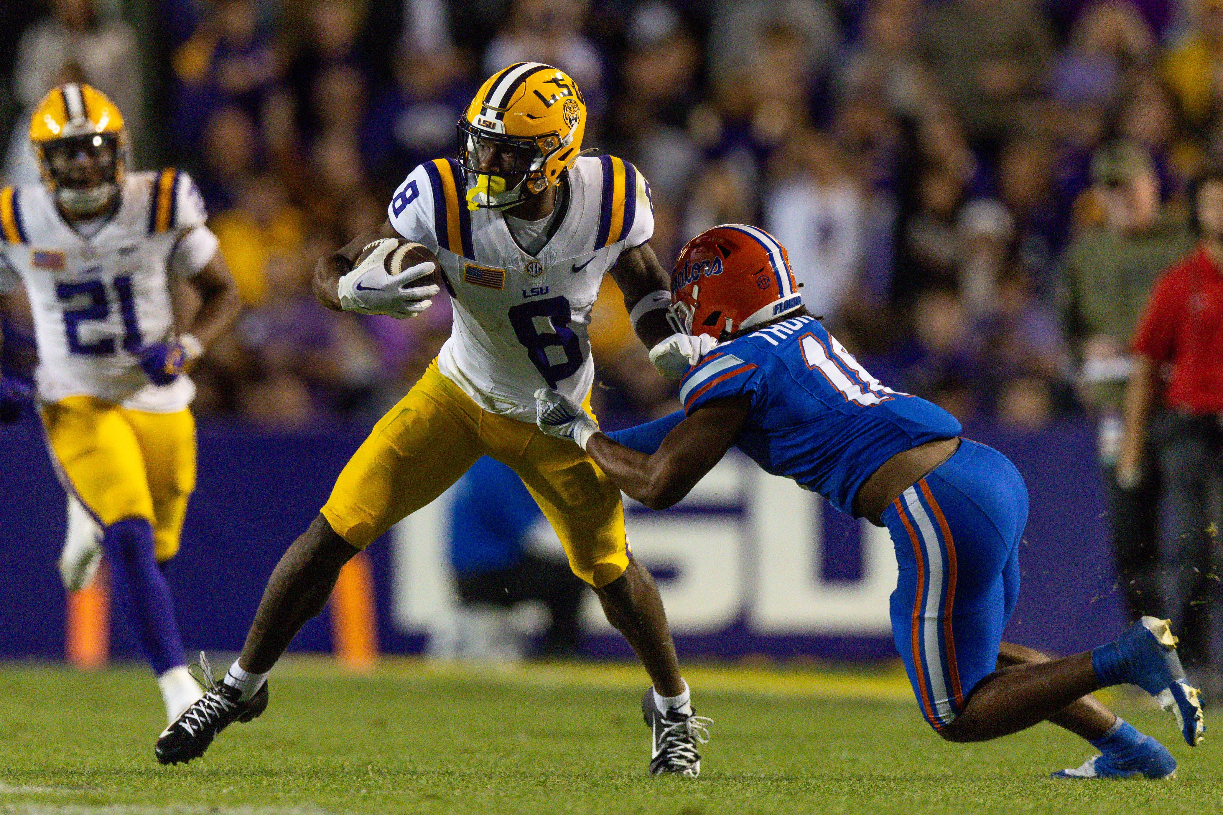 Nov 11, 2023; Baton Rouge, Louisiana, USA; Florida Gators defensive end Kelby Collins (11) attempts to tackle LSU Tigers wide receiver Malik Nabers (8) during the second half at Tiger Stadium.