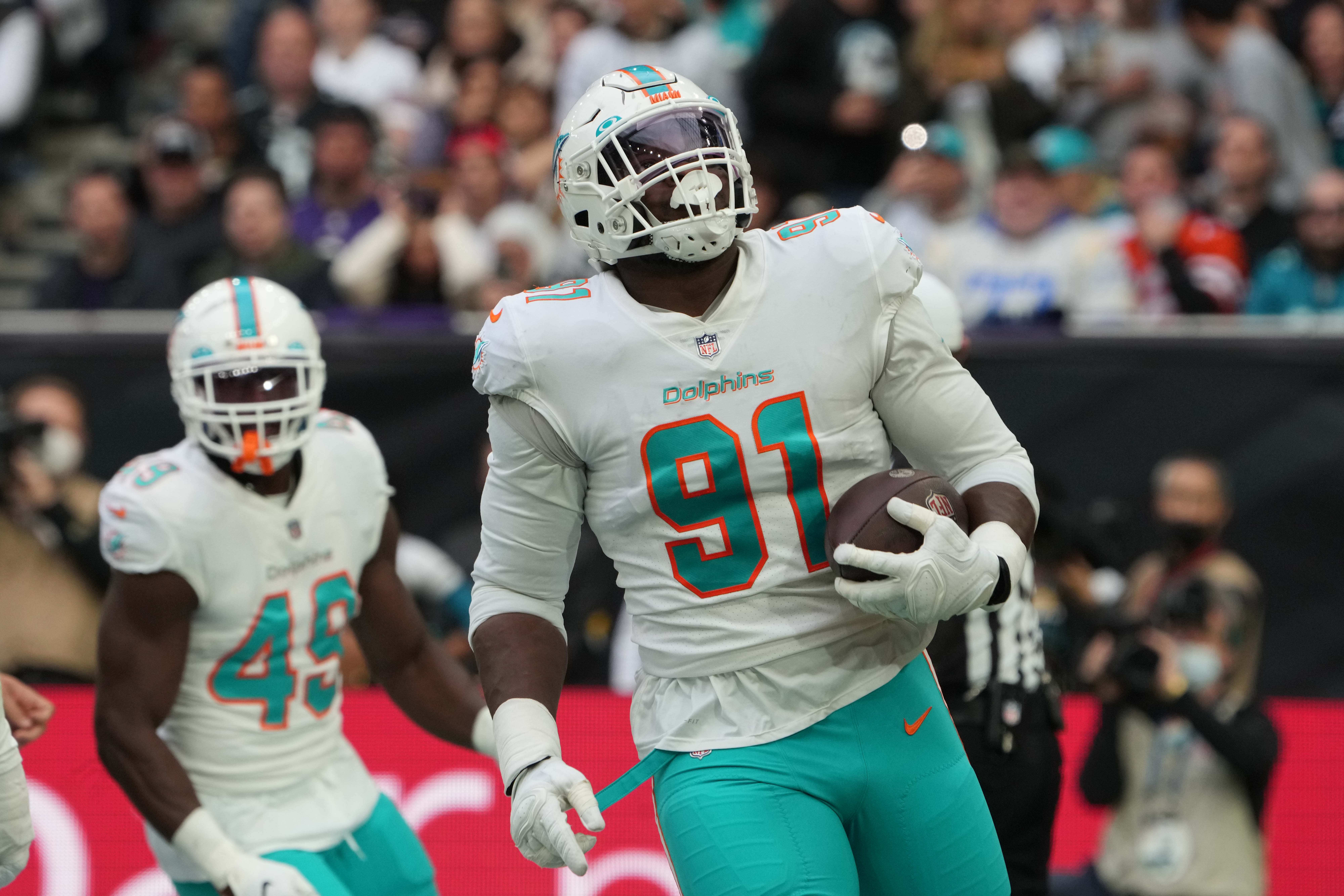 Oct 17, 2021; London, England, United Kingdom; Miami Dolphins defensive end Emmanuel Ogbah (91) celebrates after deflecting a pass in the second quarter against the Jacksonville Jaguars during an NFL International Series game at Tottenham Hotspur Stadium.