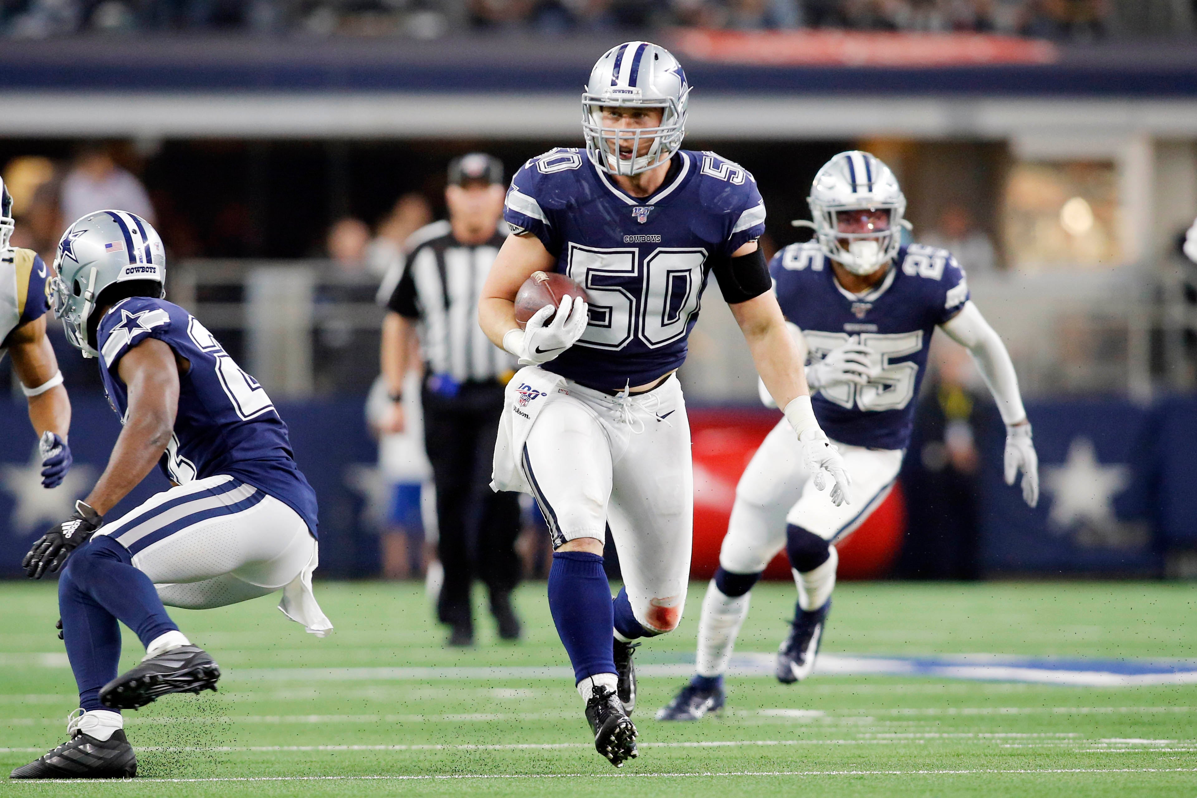 Dallas Cowboys outside linebacker Sean Lee (50) returns an interception in the second quarter against the Los Angeles Rams at AT&T Stadium.