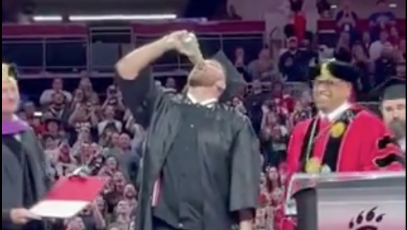 Travis Kelce chugs a beer after receiving his diploma from the University of Cincinnati