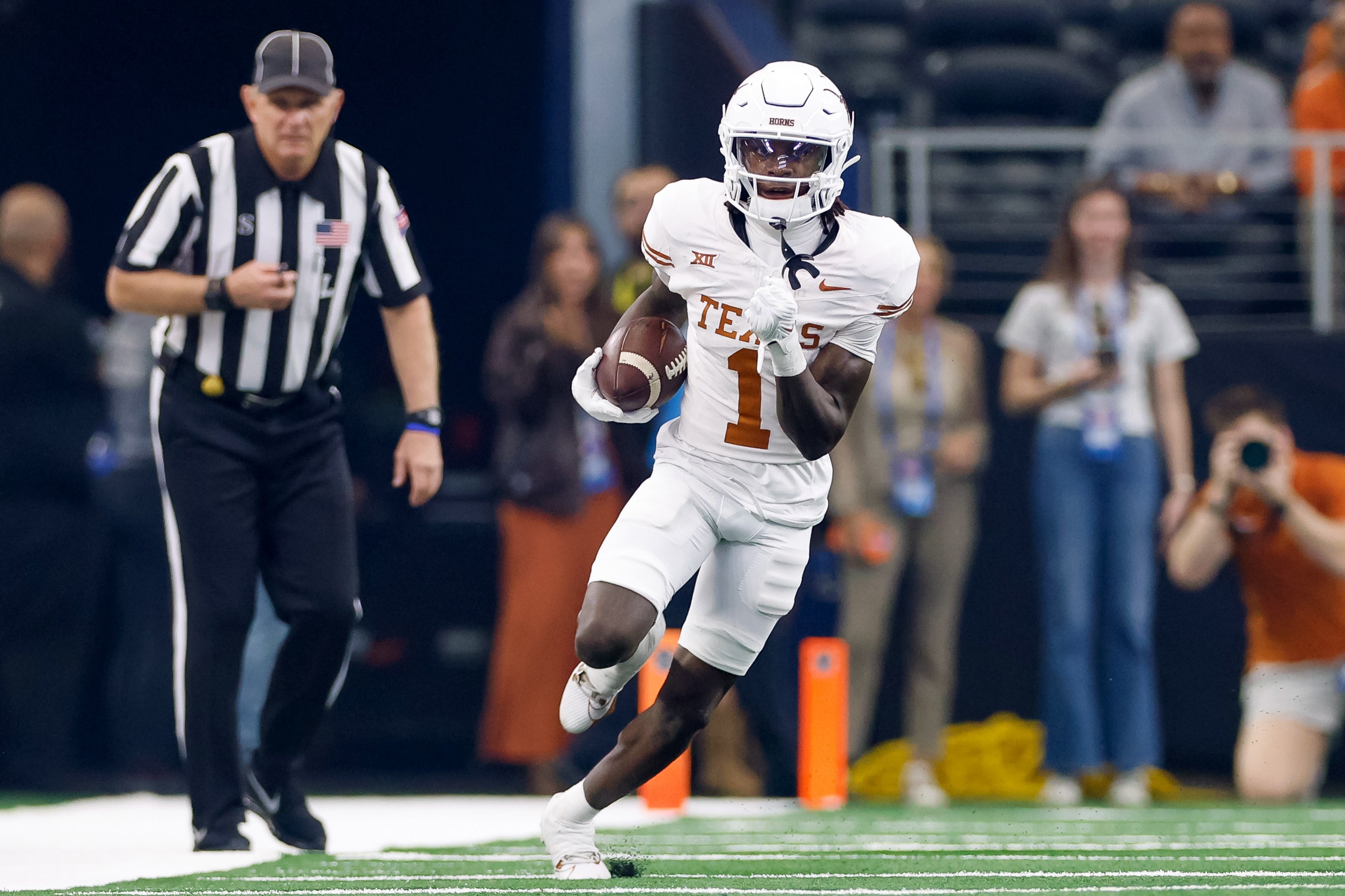 Dec 2, 2023; Arlington, TX, USA; Texas Longhorns wide receiver Xavier Worthy (1) runs with the ball during the first quarter against the Oklahoma State Cowboys at AT&T Stadium.
