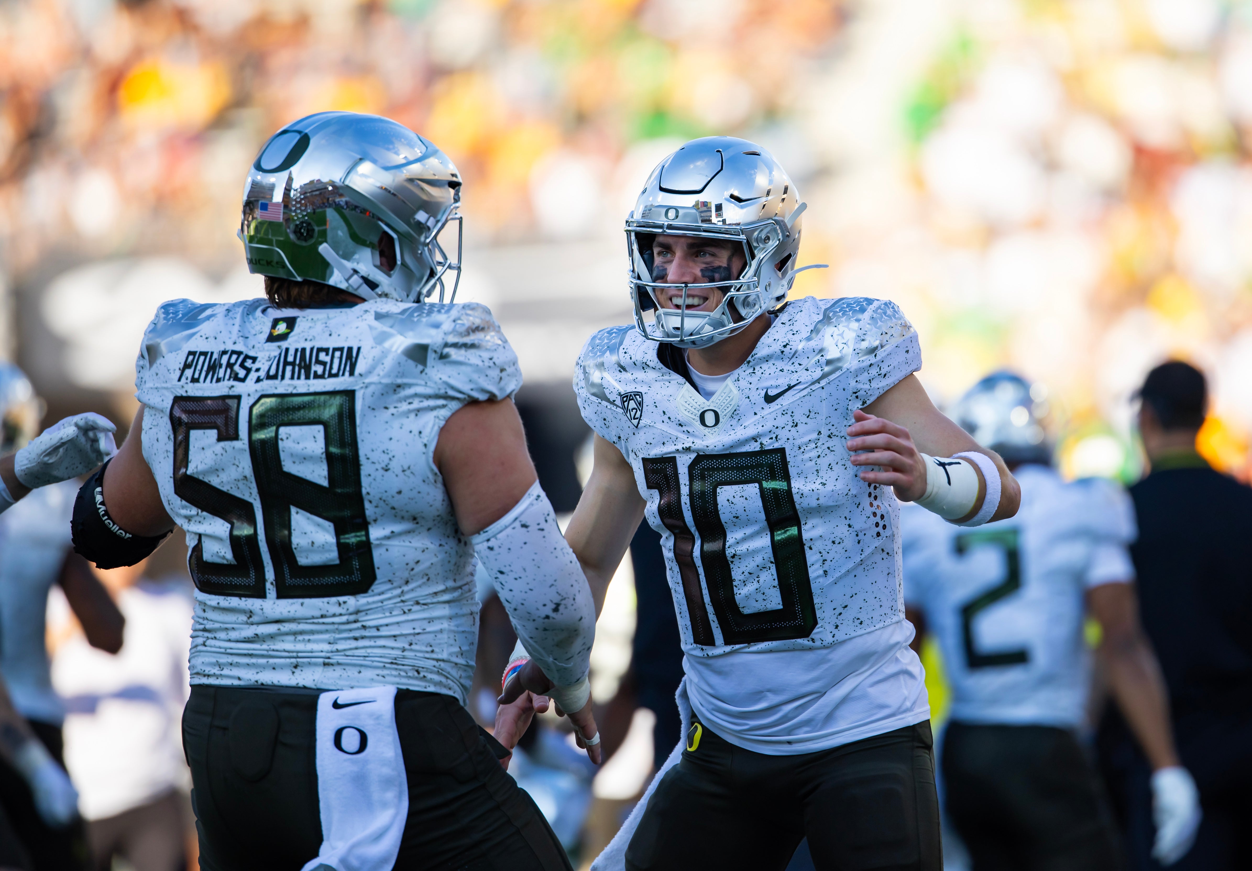Nov 18, 2023; Tempe, Arizona, USA; Oregon Ducks quarterback Bo Nix (10) celebrates a touchdown with offensive lineman Jackson Powers-Johnson (58) against the Arizona State Sun Devils in the first half at Mountain America Stadium. Mandatory Credit: Mark J. Rebilas-USA TODAY Sports