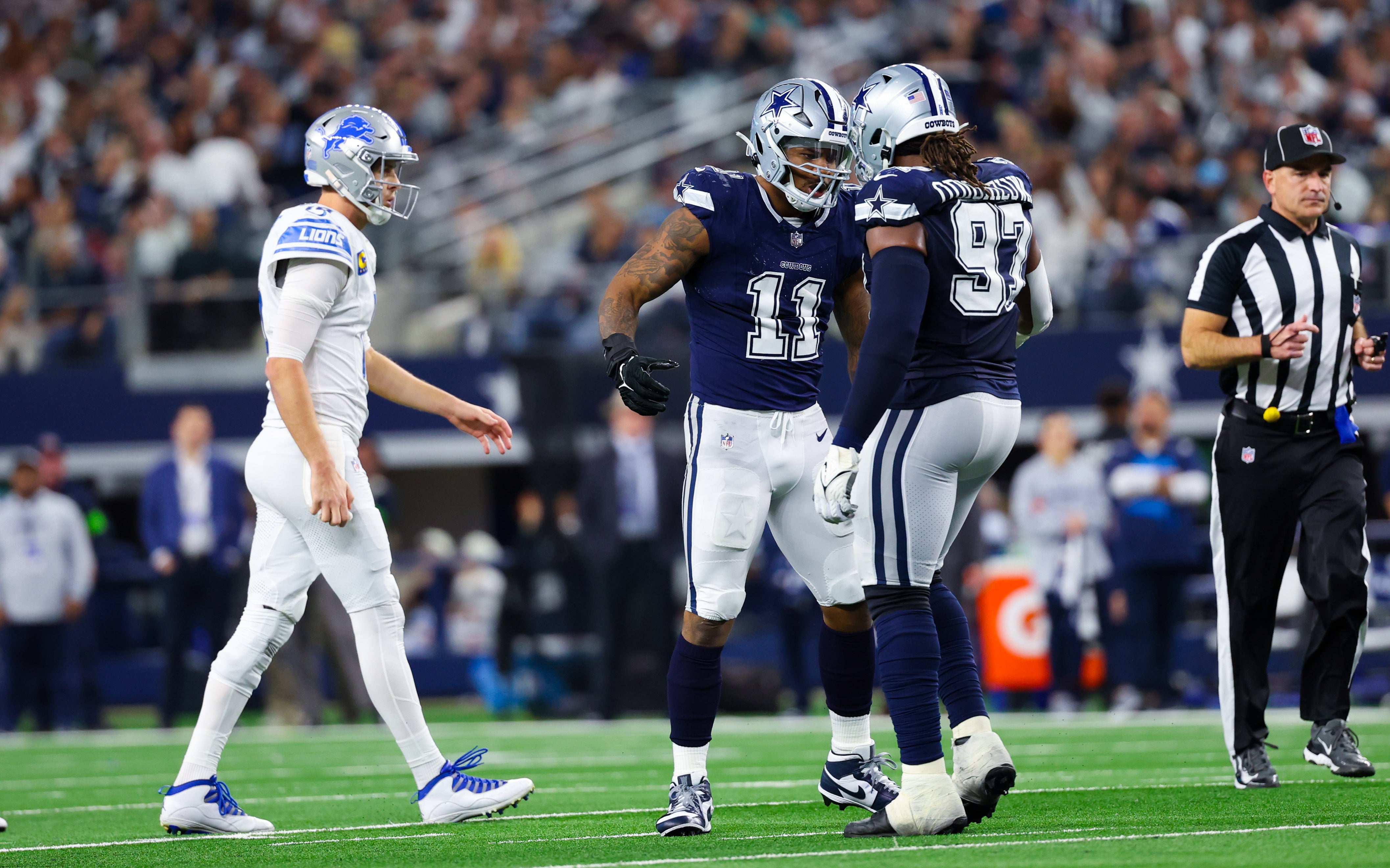 Dallas Cowboys linebacker Micah Parsons (11) celebrates with Dallas Cowboys defensive tackle Osa Odighizuwa (97) in front of Detroit Lions quarterback Jared Goff (16) during the second half at AT&T Stadium.