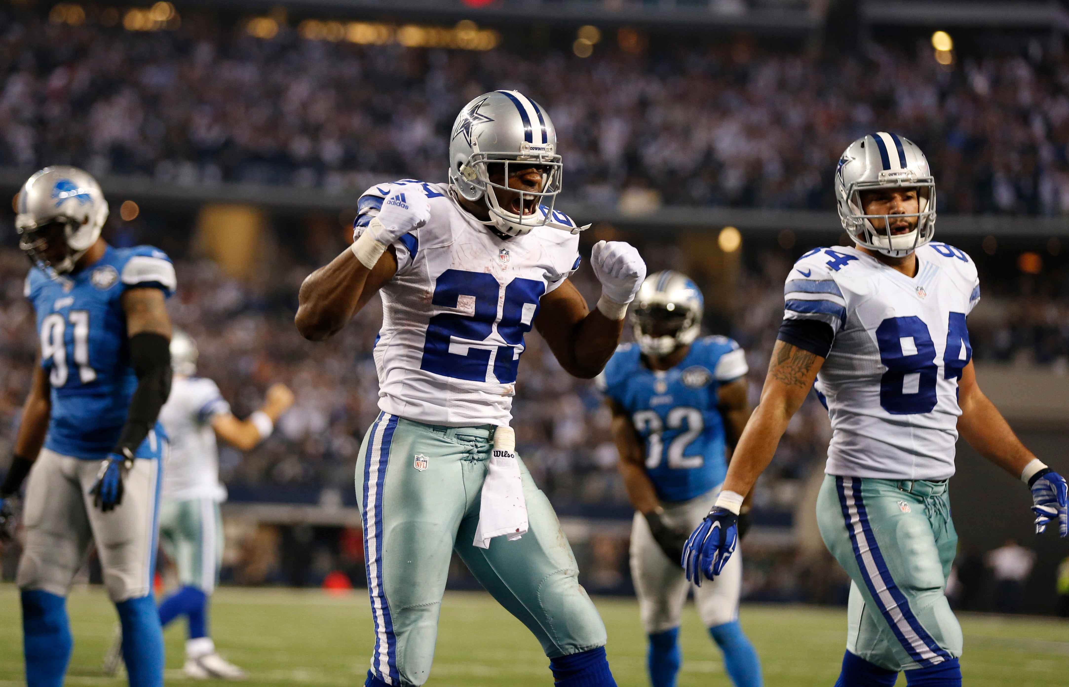 Dallas Cowboys running back DeMarco Murray (29) reacts after scoring a touchdown against the Detroit Lions during the third quarter in the NFC Wild Card Playoff Game at AT&T Stadium.